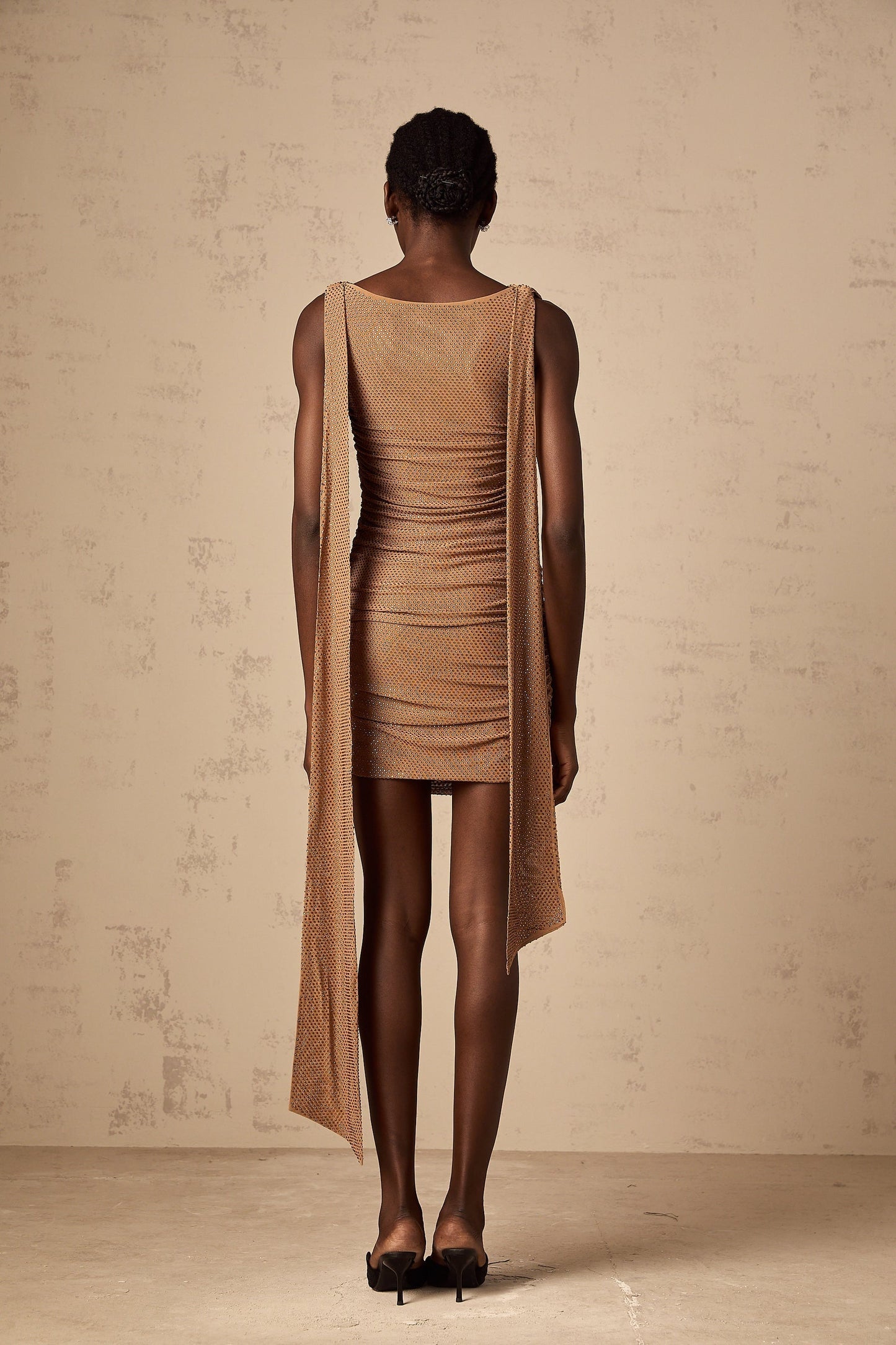 A short brown dress with rhinestone embellishments and a mini length featuring a design named Jacqueline