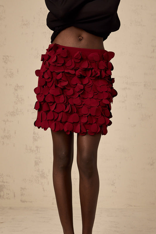 A short flared mini skirt with threedimensional petallike details creating a textured Aline silhouette