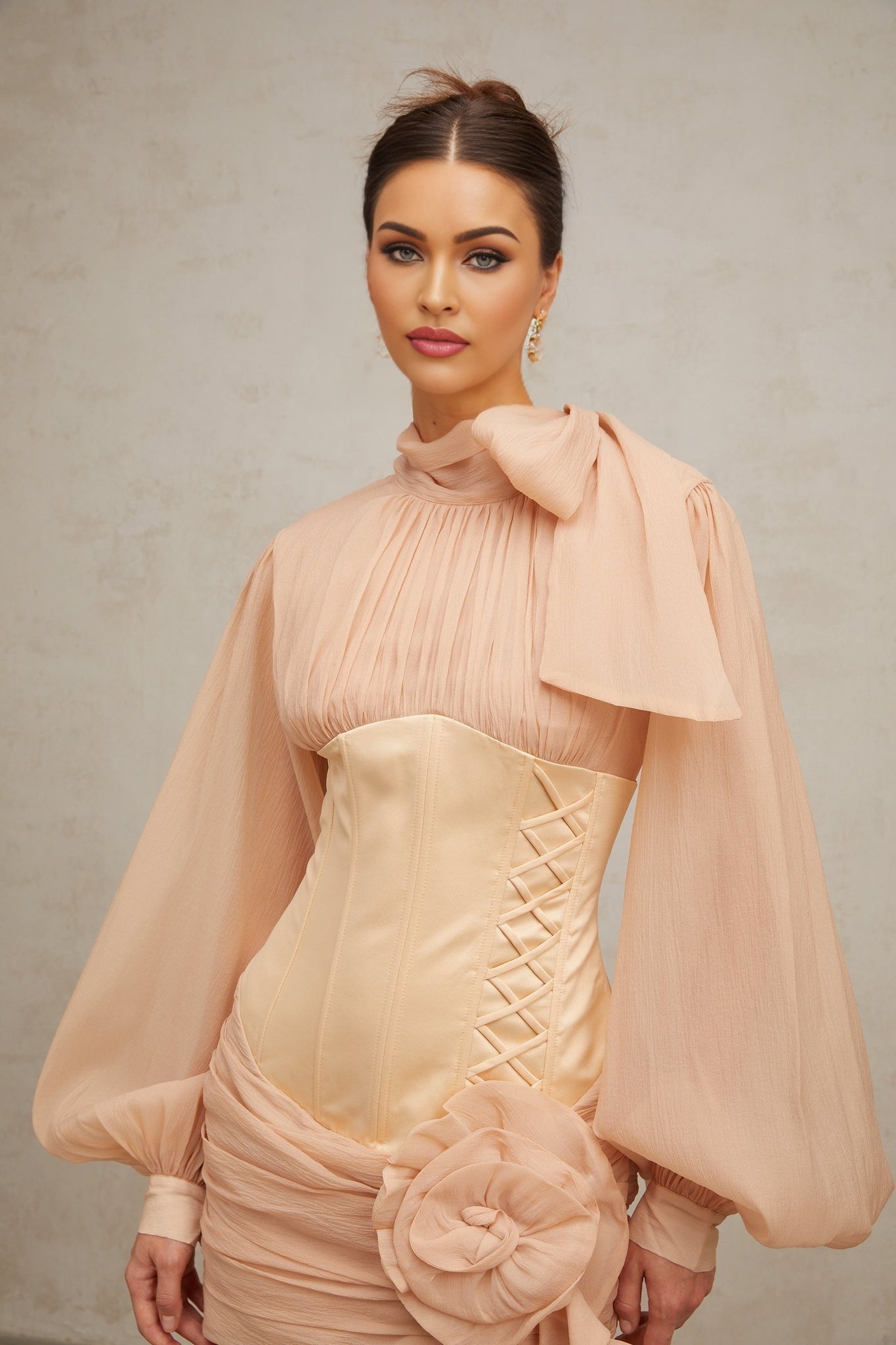 A short floral dress with cinched waist and applique details featuring panels and a mini length