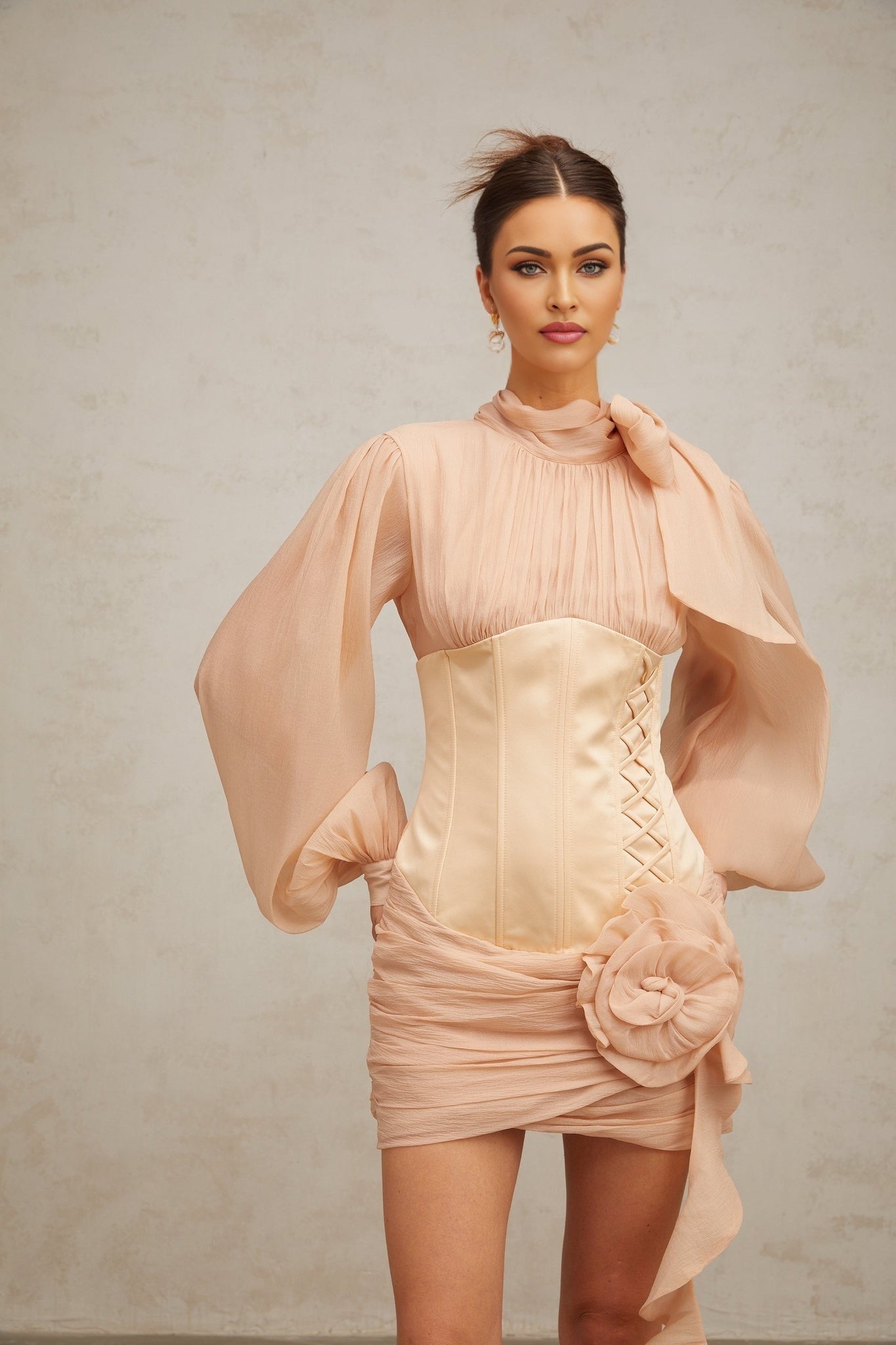 A short floral dress with cinched waist and floral applique details featuring panels and a mini length