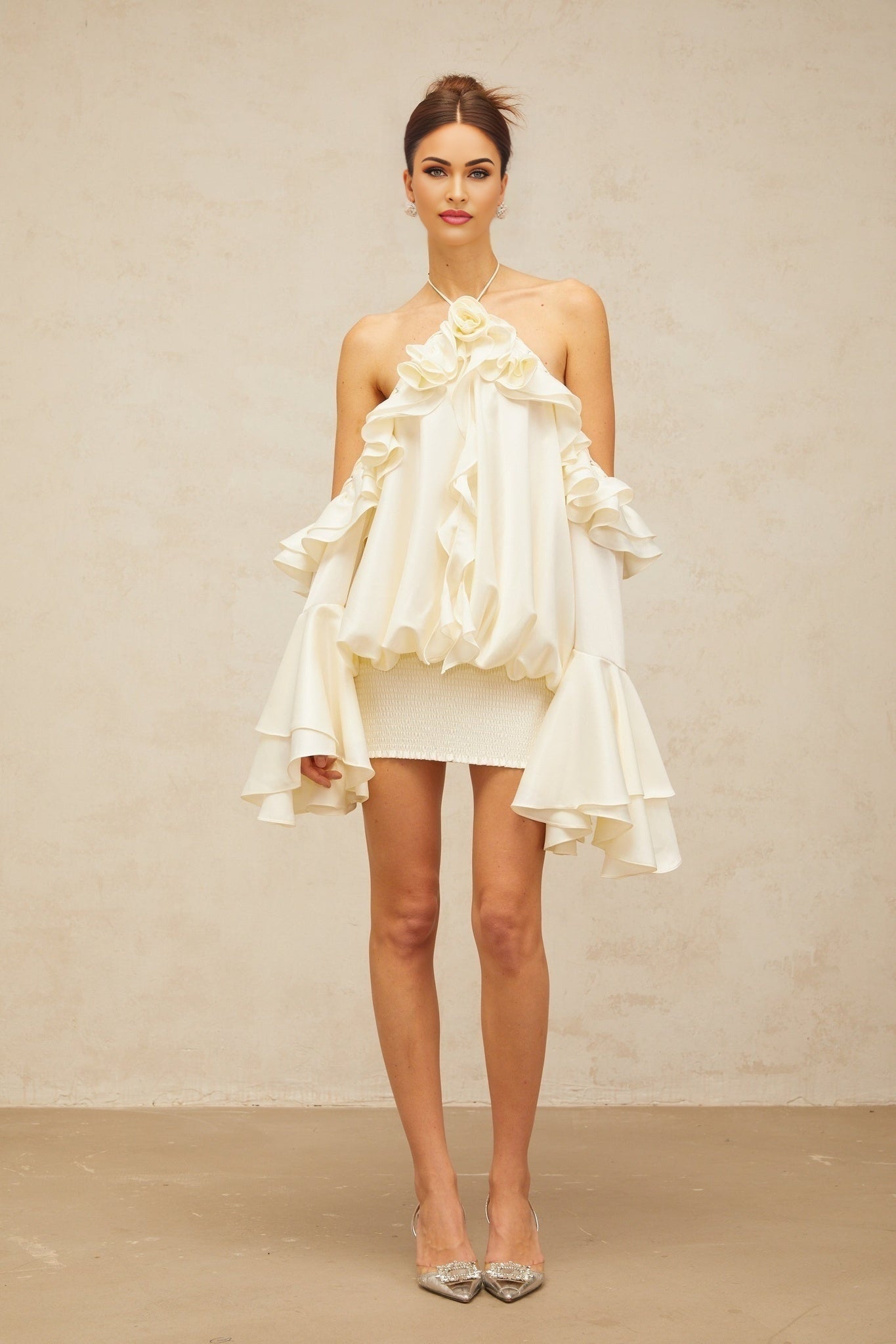 A short floral dress with ruffles and cold shoulder design featuring a vibrant floral pattern on a light background