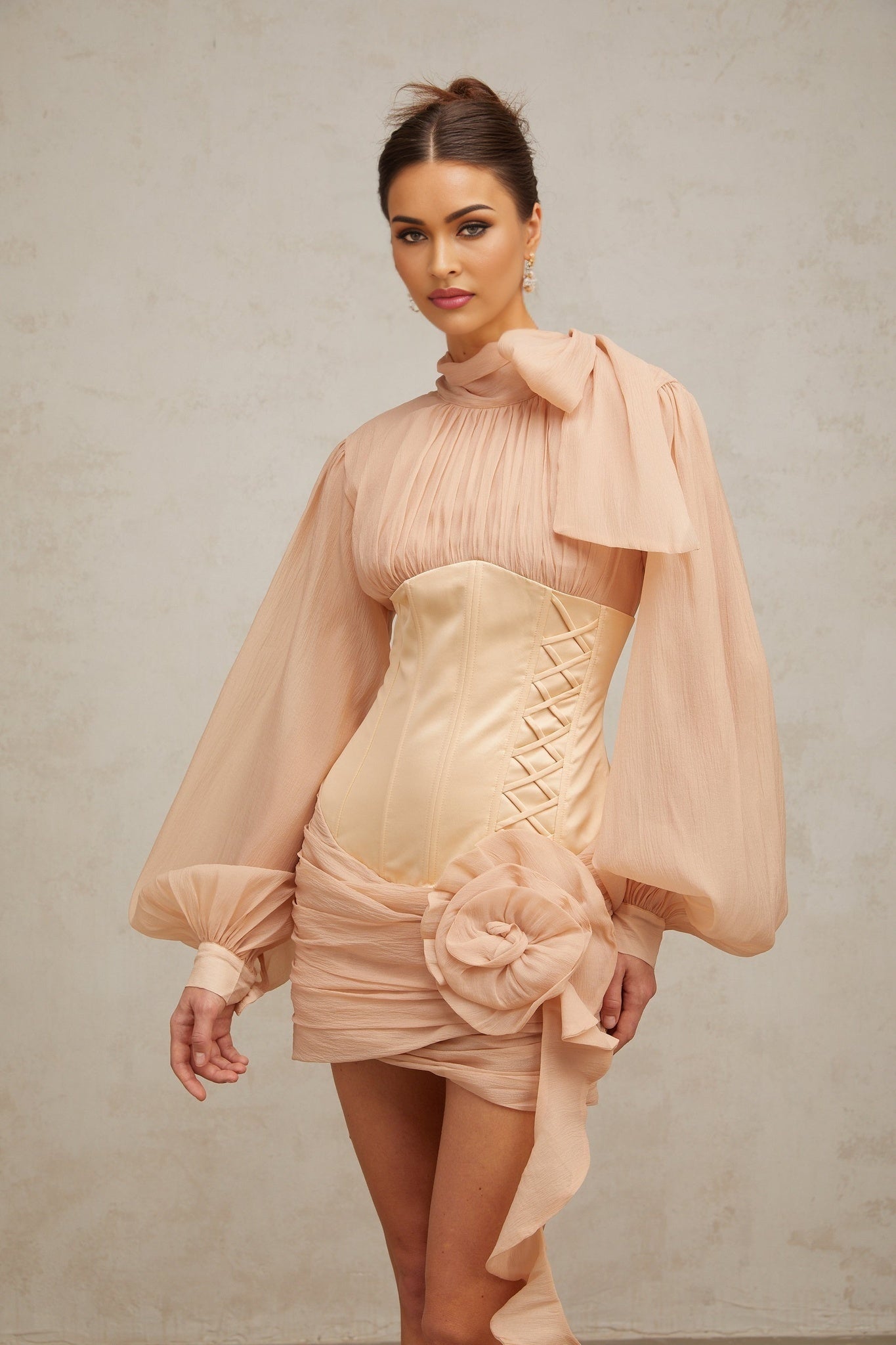 A short floral mini dress with cinched waist and applique details featuring paneled construction