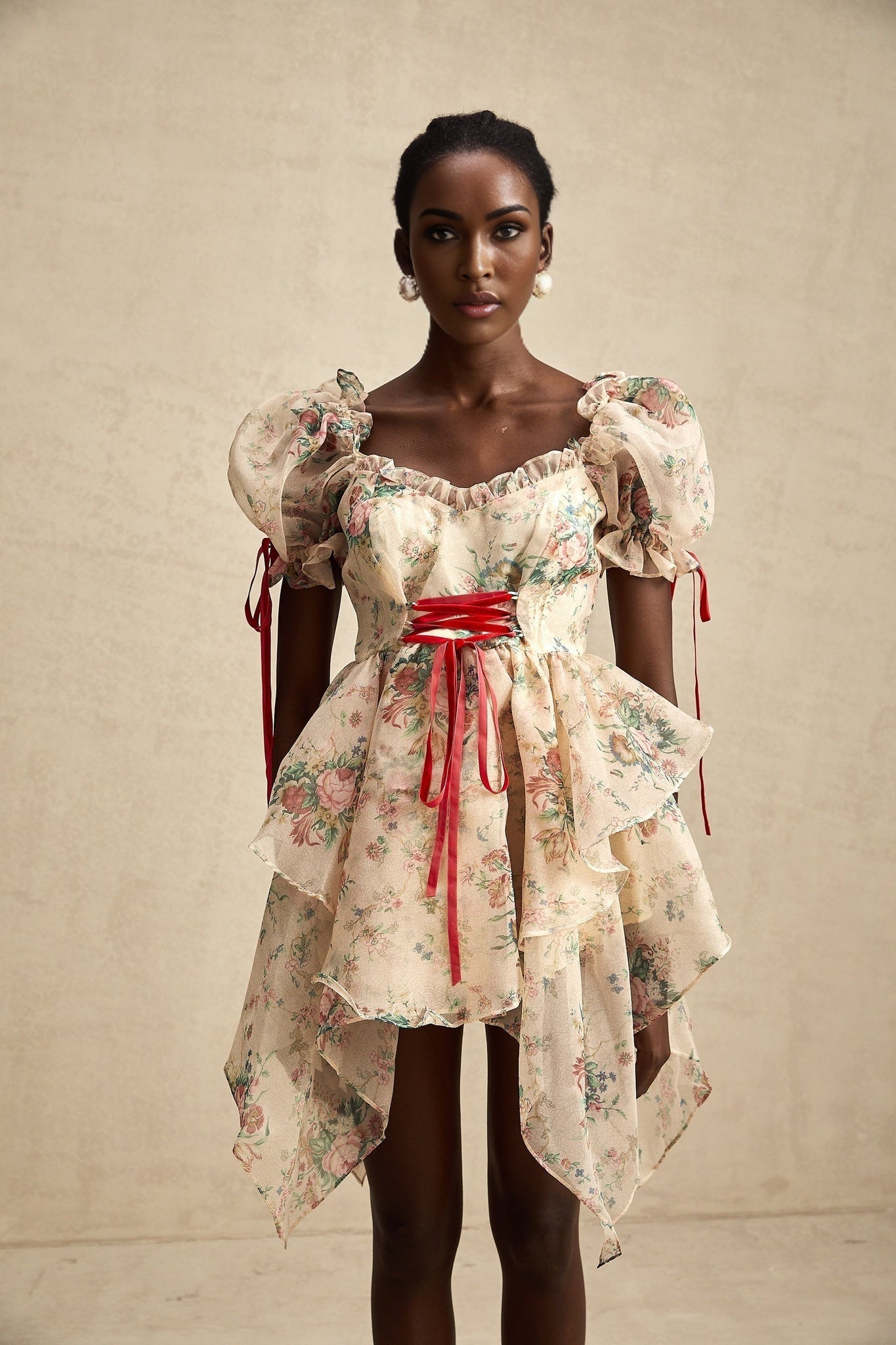 A short floral print dress with a layered tulle skirt and tieup details named Salome featuring a mini length and vibrant floral pattern