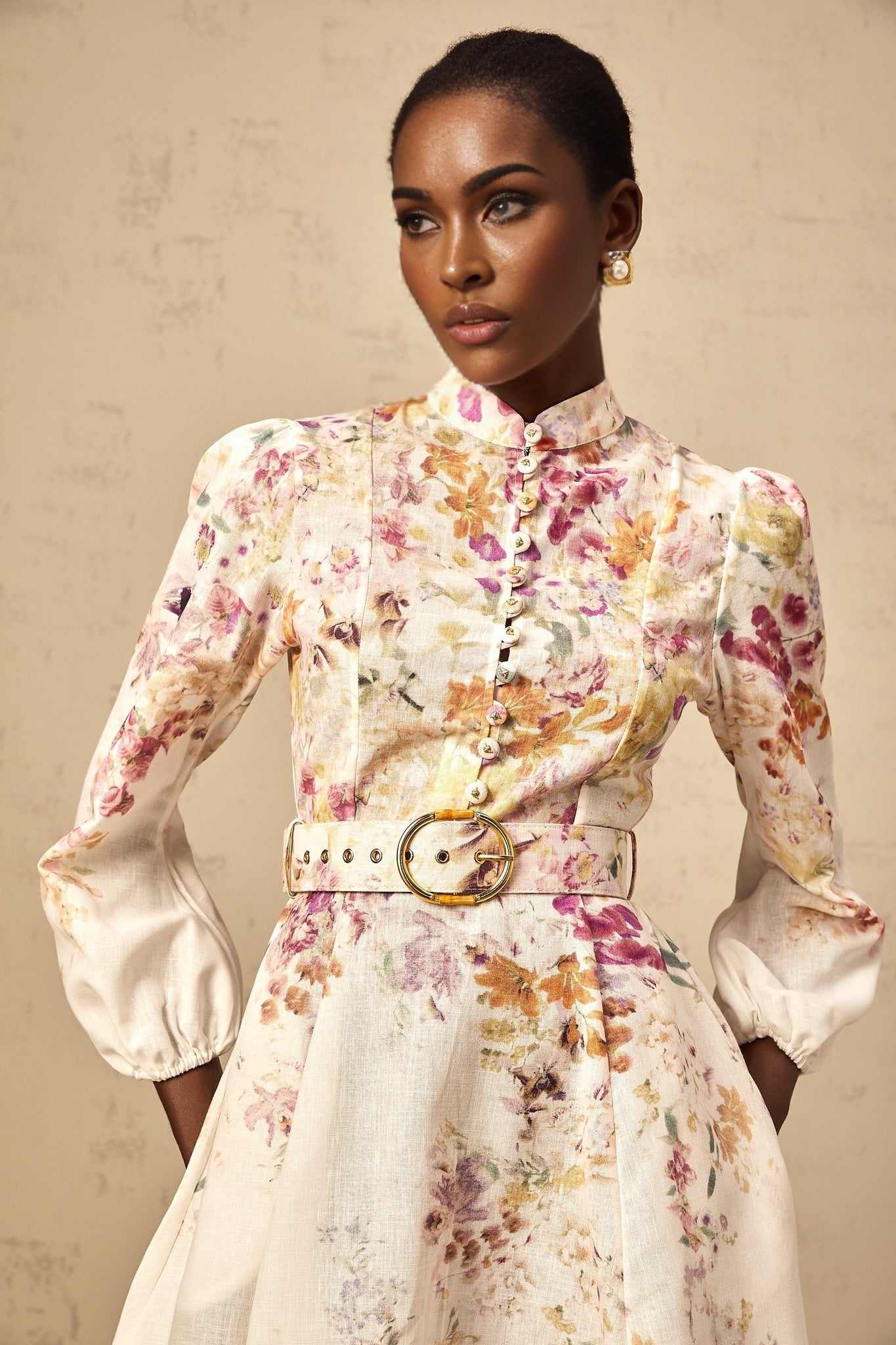 A short floral print dress with a white background and colorful flower pattern featuring a fitted bodice and flared skirt