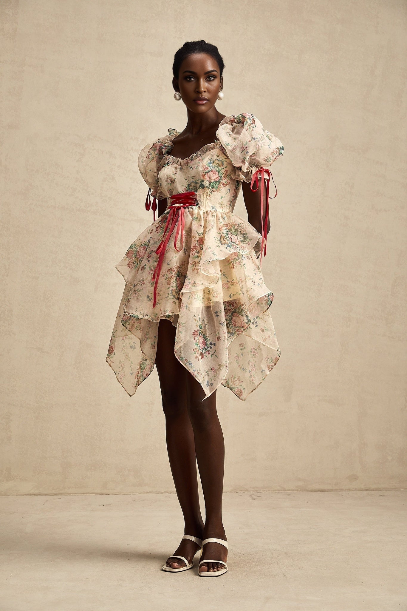 A short floral print dress with layered tulle skirt and tie up detail named Salome