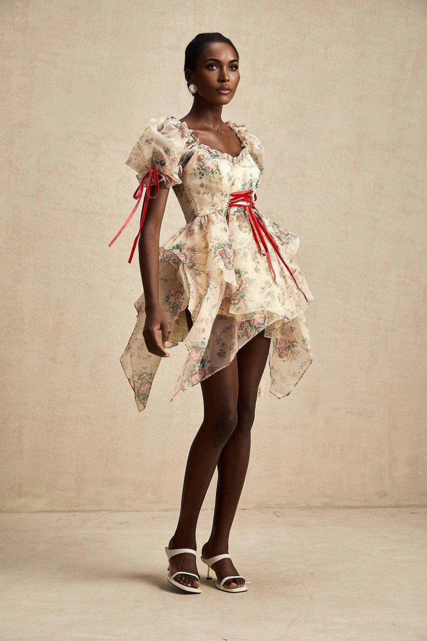 A short floral print dress with tulle layers and tie up details in a mini length style