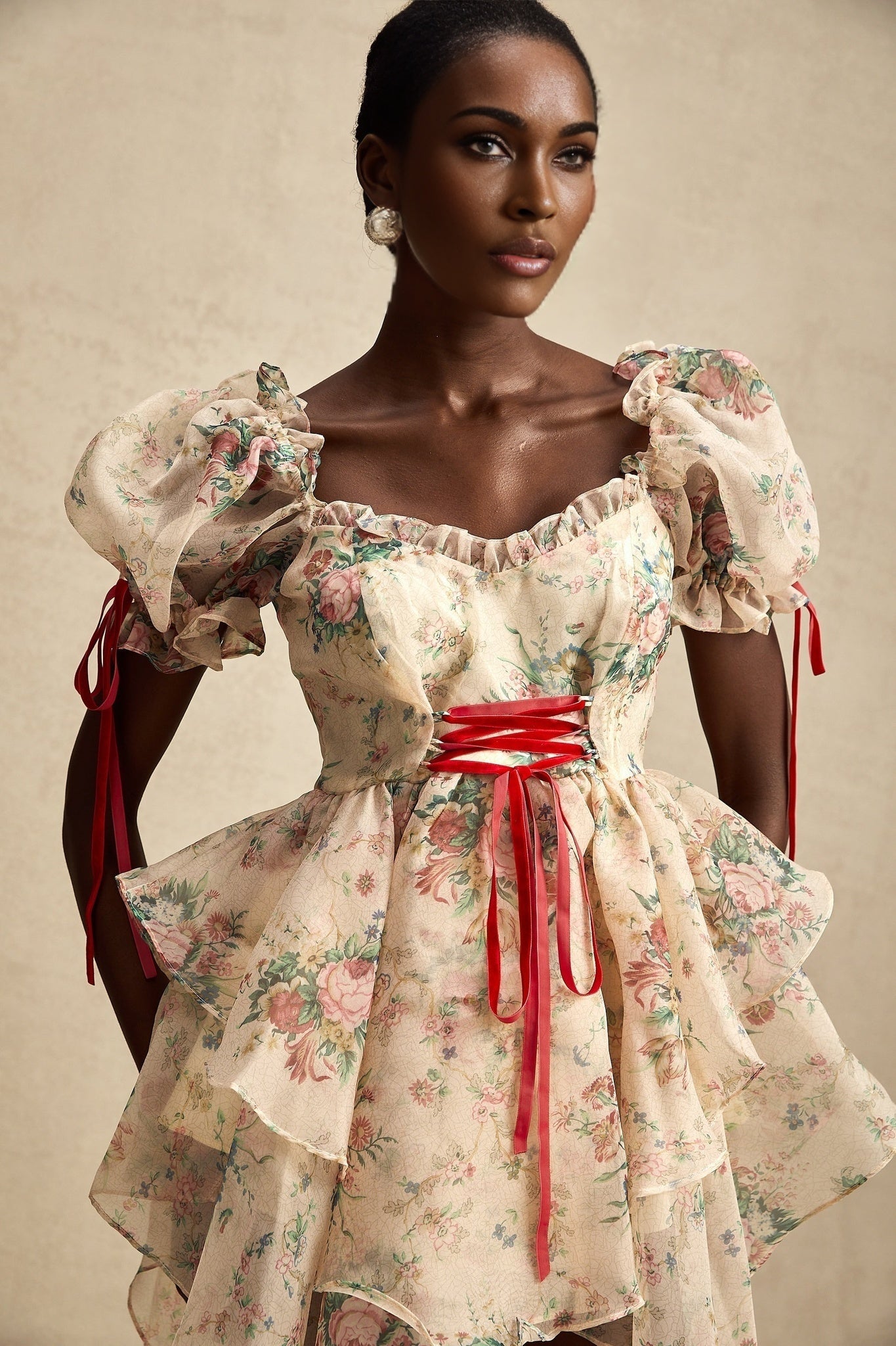 A short floral print mini dress with a layered tulle skirt and tieup details named Salome