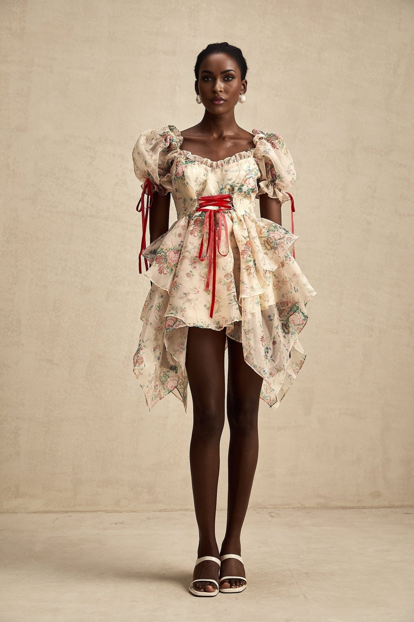 A short floral print mini dress with a layered tulle skirt and tieup details named Salome