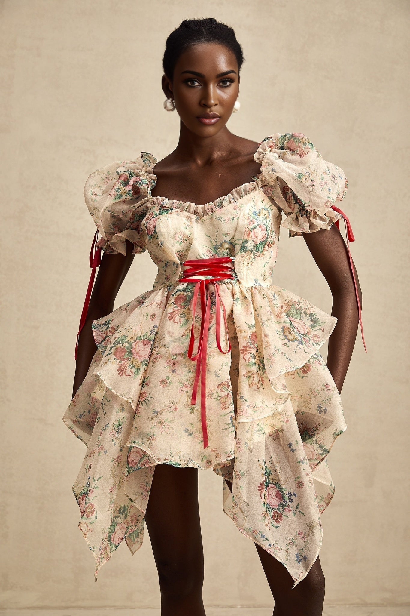 A short floral print mini dress with layered tulle skirt and tie up detail named Salome