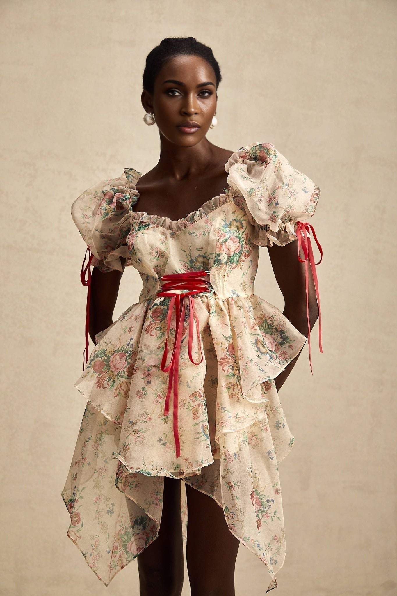 A short floral print mini dress with layered tulle skirt and tieup details named Salome featuring a vibrant floral pattern on a light background