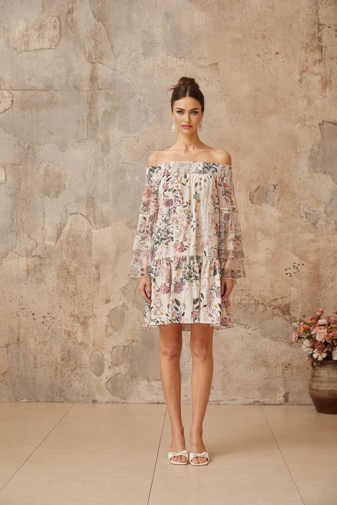 A short floral print mini dress with smocked detailing named Yasmine featuring a colorful floral pattern on a lightweight fabric with a fitted bodice and flowy skirt
