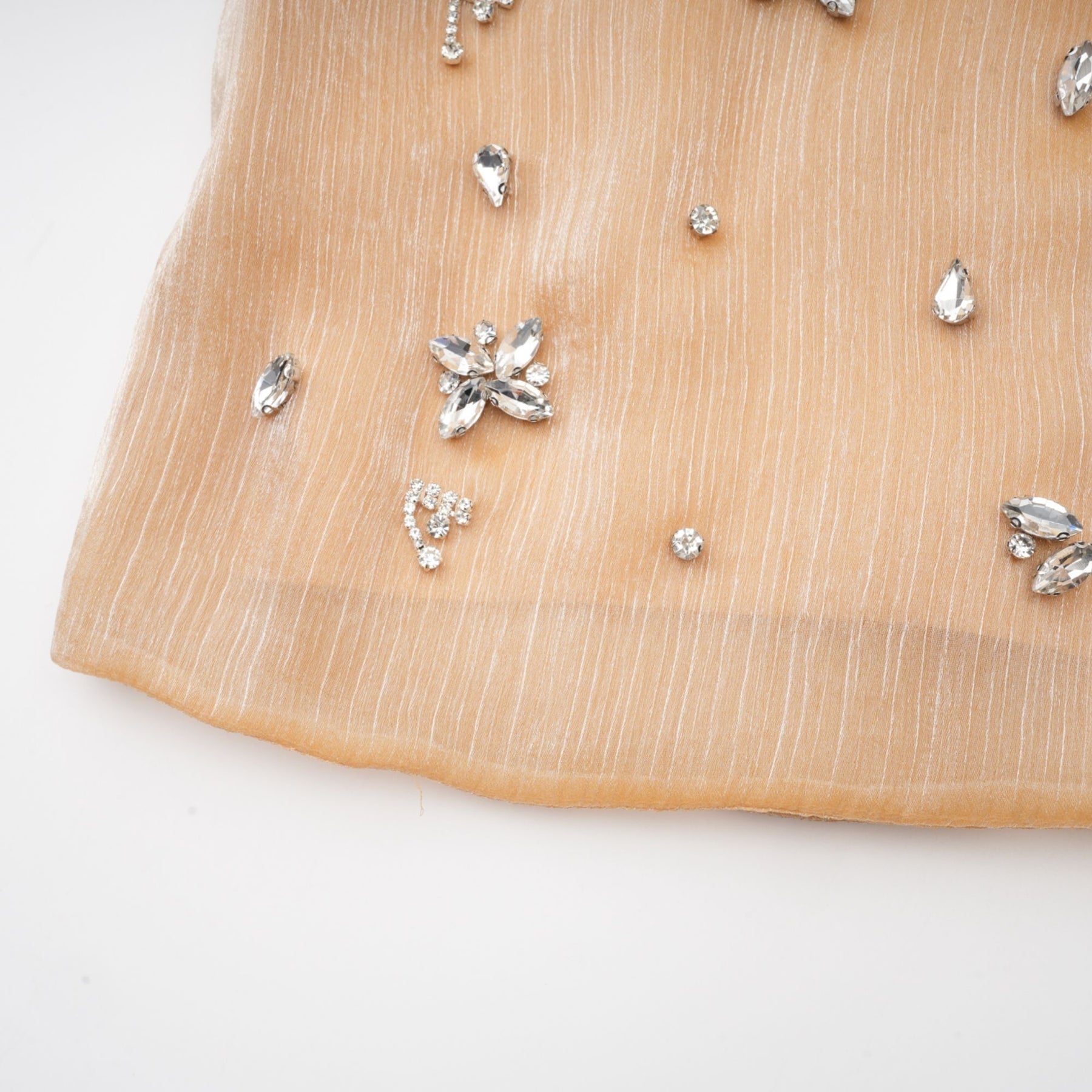 A short gold dress with crystal embellishments and panels shimmering in the light elegant cocktail attire for special occasions