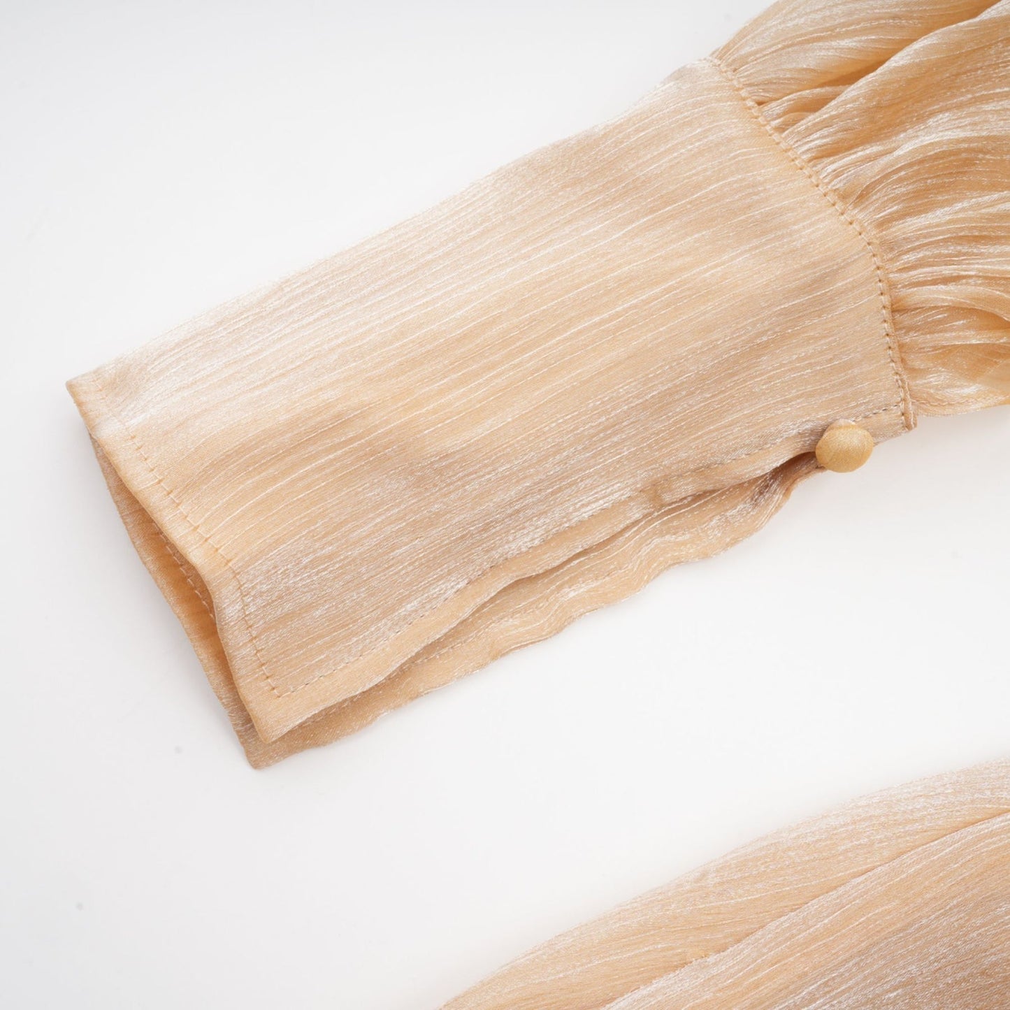 A short gold mini dress with crystal embellishments and panelled design featuring a sleeveless silhouette and shimmering fabric