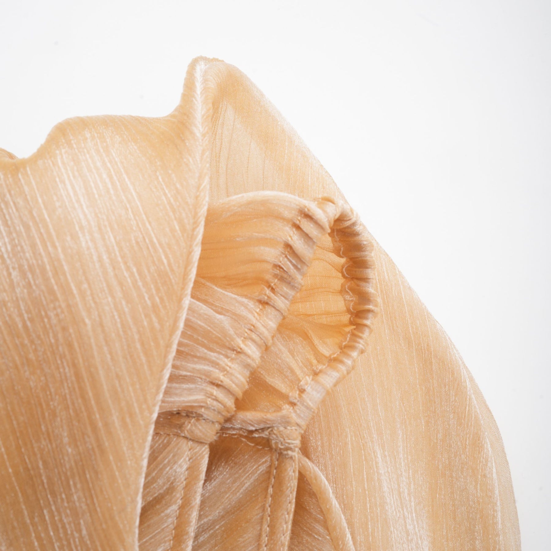 A short gold mini dress with crystal embellishments and panelled design featuring a sleeveless style and fitted silhouette