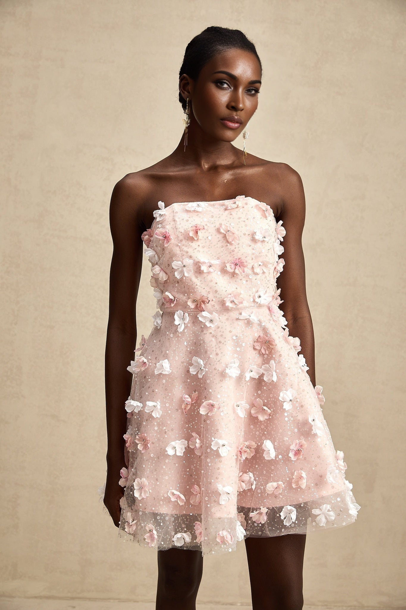 A short pastel mini dress with prominent three dimensional petal details creating a puffy textured appearance