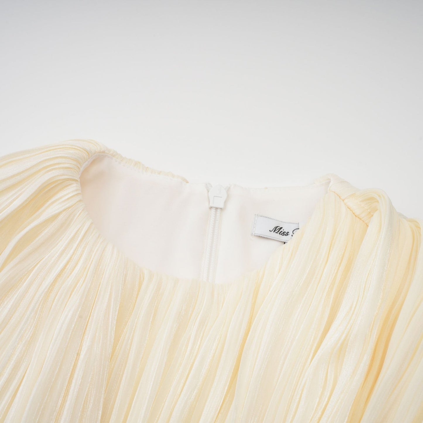 A short pleated mini dress with a ribbon design accent named Cyrielle