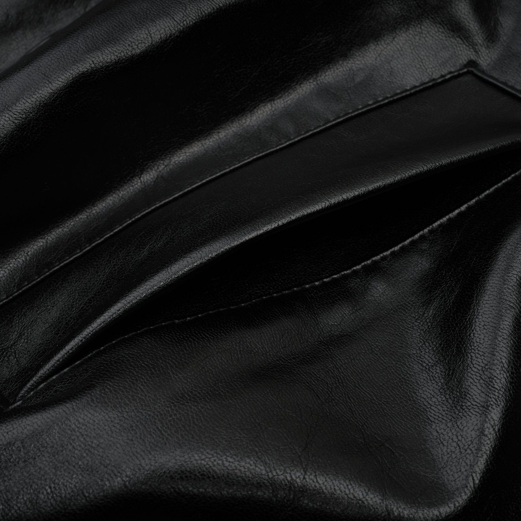 A short quilted leather jacket in black featuring a sleek design with front zipper closure and standup collar