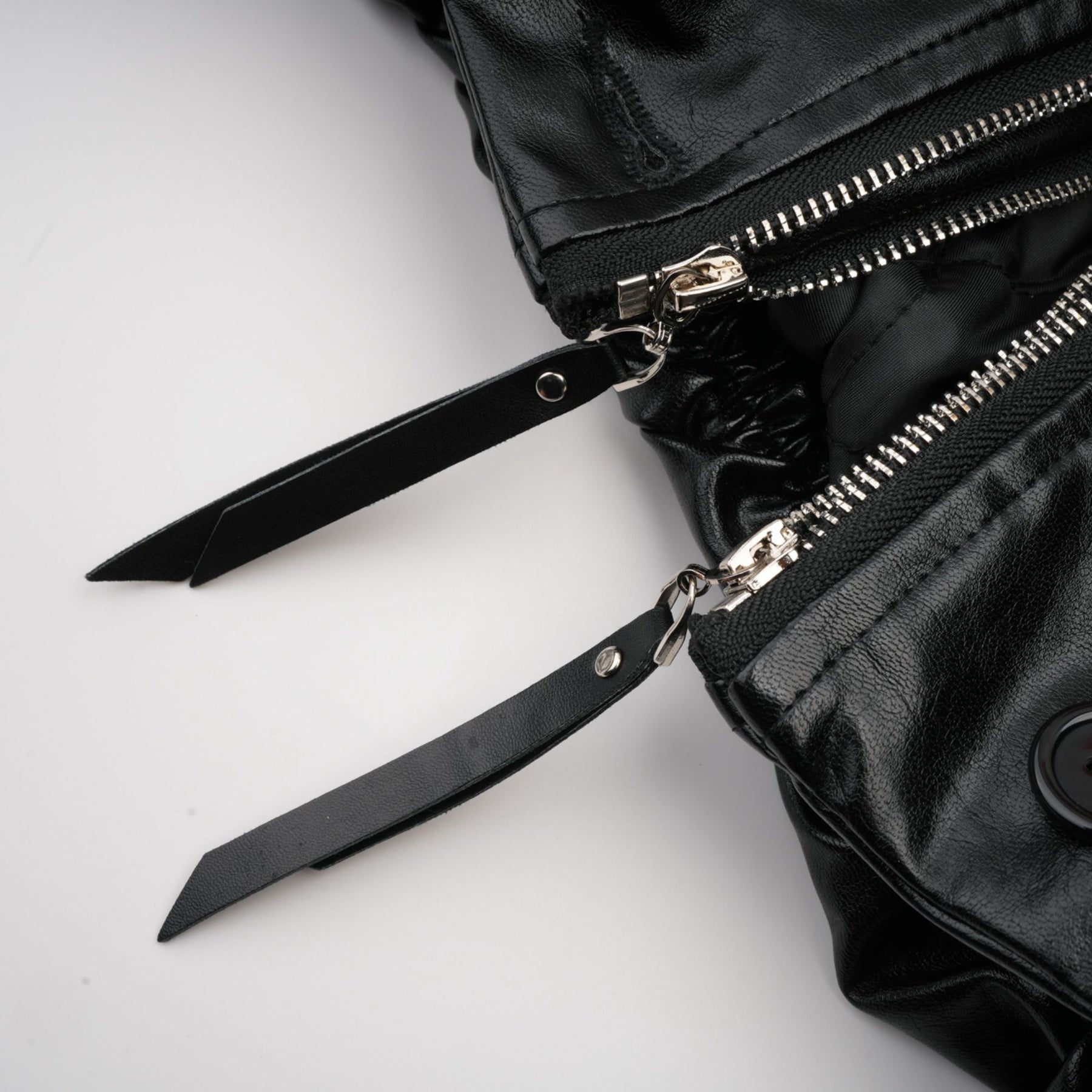 A short quilted leather jacket in black featuring a standup collar front zipper pockets and ribbed cuffs