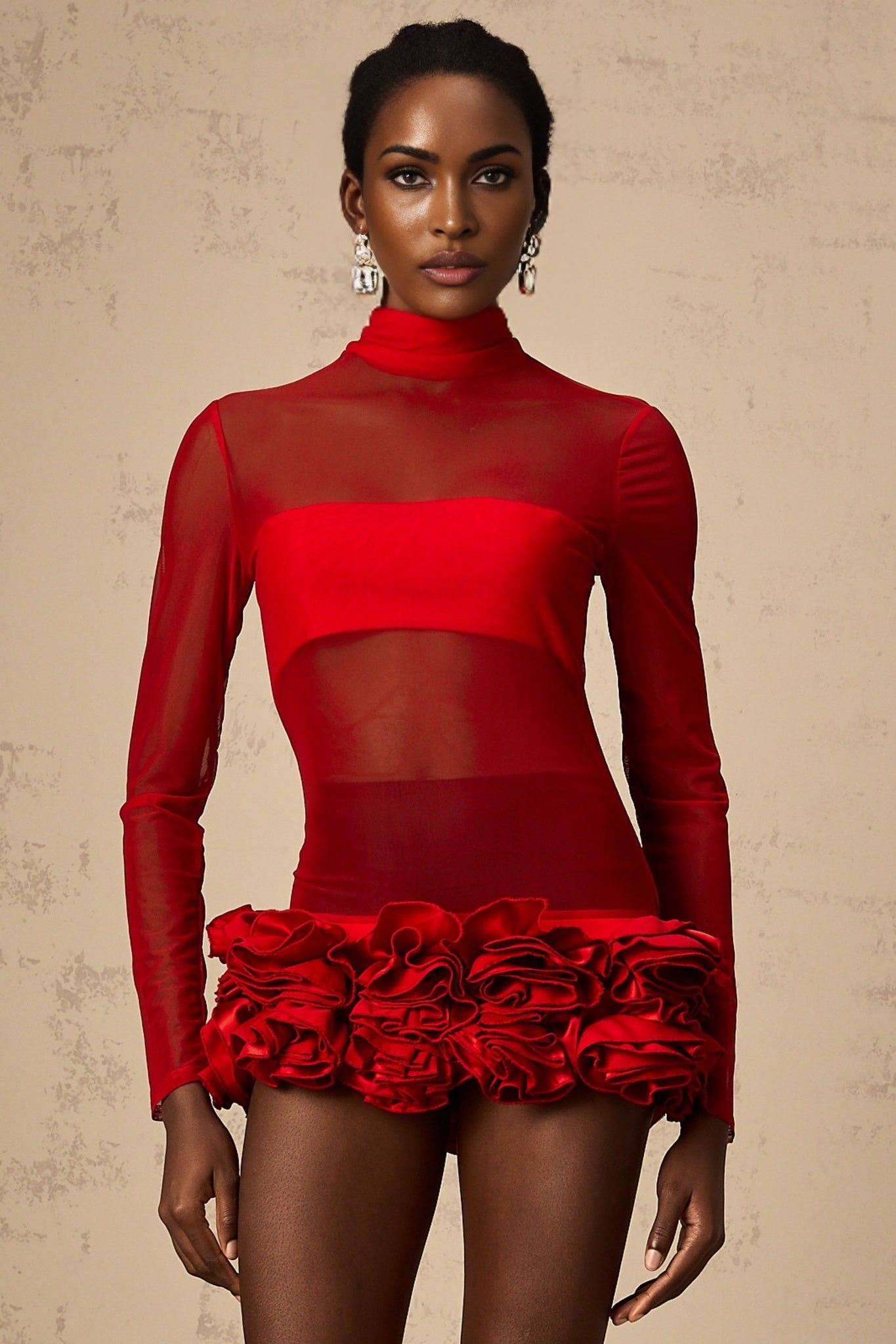 A short red mini dress with a semisheer tulle overlay featuring threedimensional petal details covering the bodice and skirt