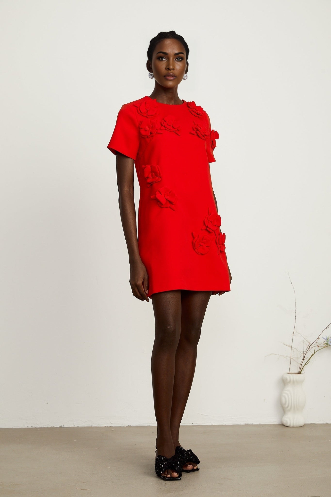 A short red mini dress with floral details and short sleeves