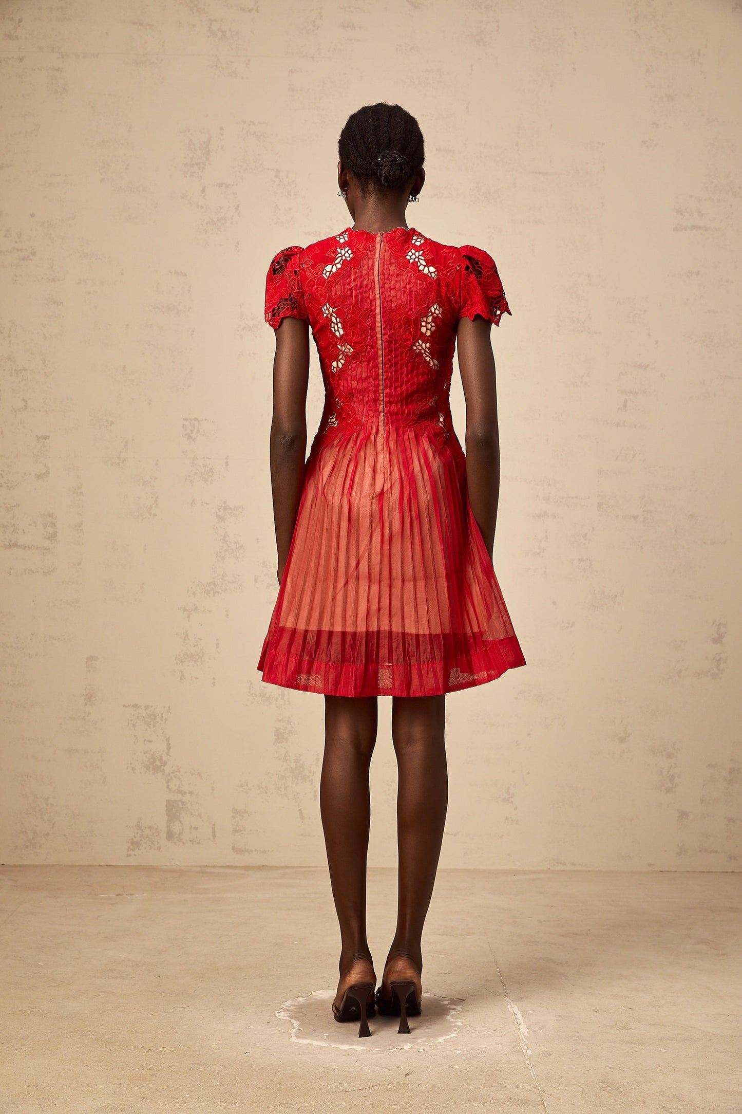 A short red mini dress with pleated skirt and floral embroidery details named Corinne