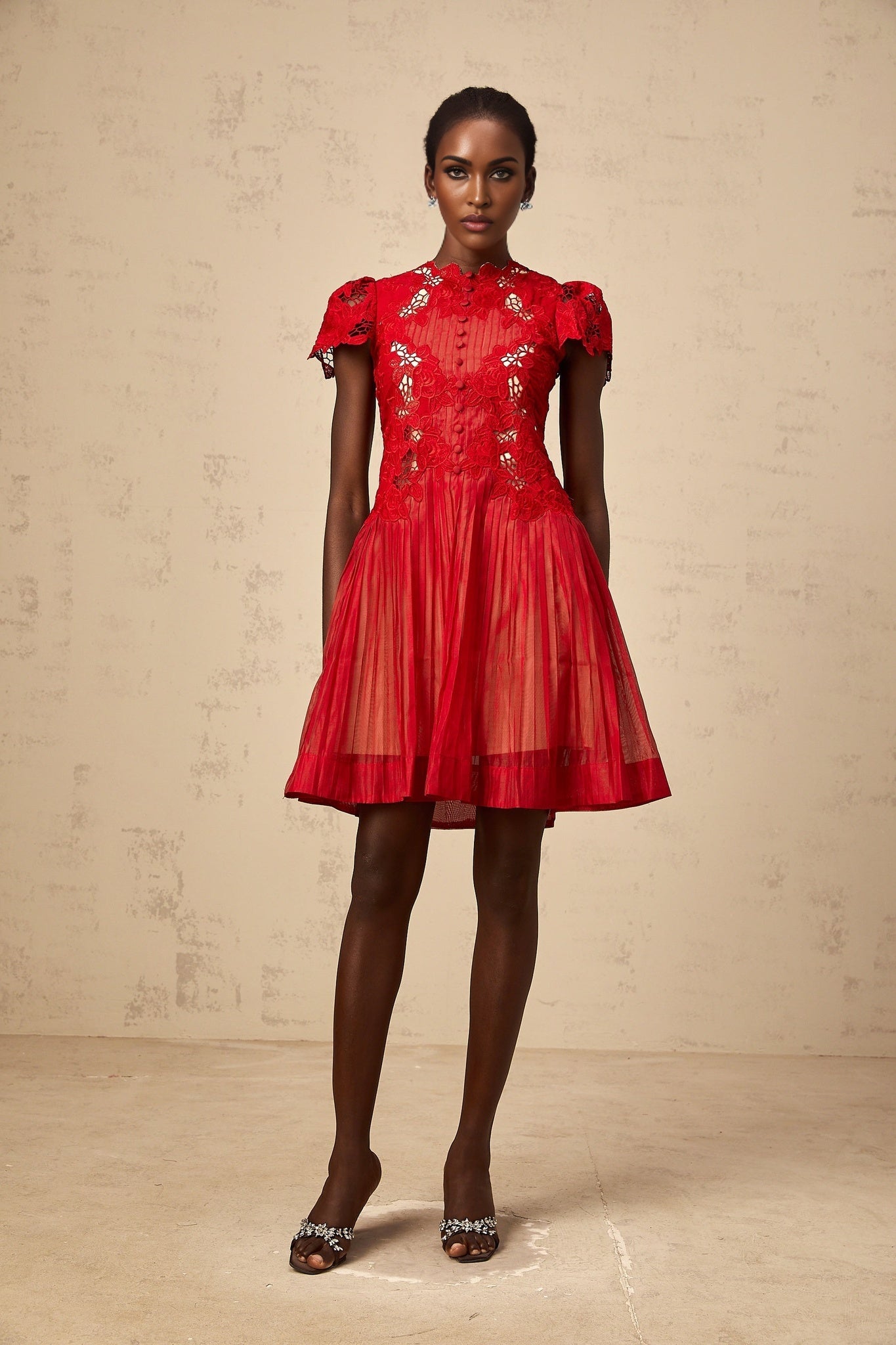 A short red mini dress with pleated skirt and floral embroidery details named Corinne