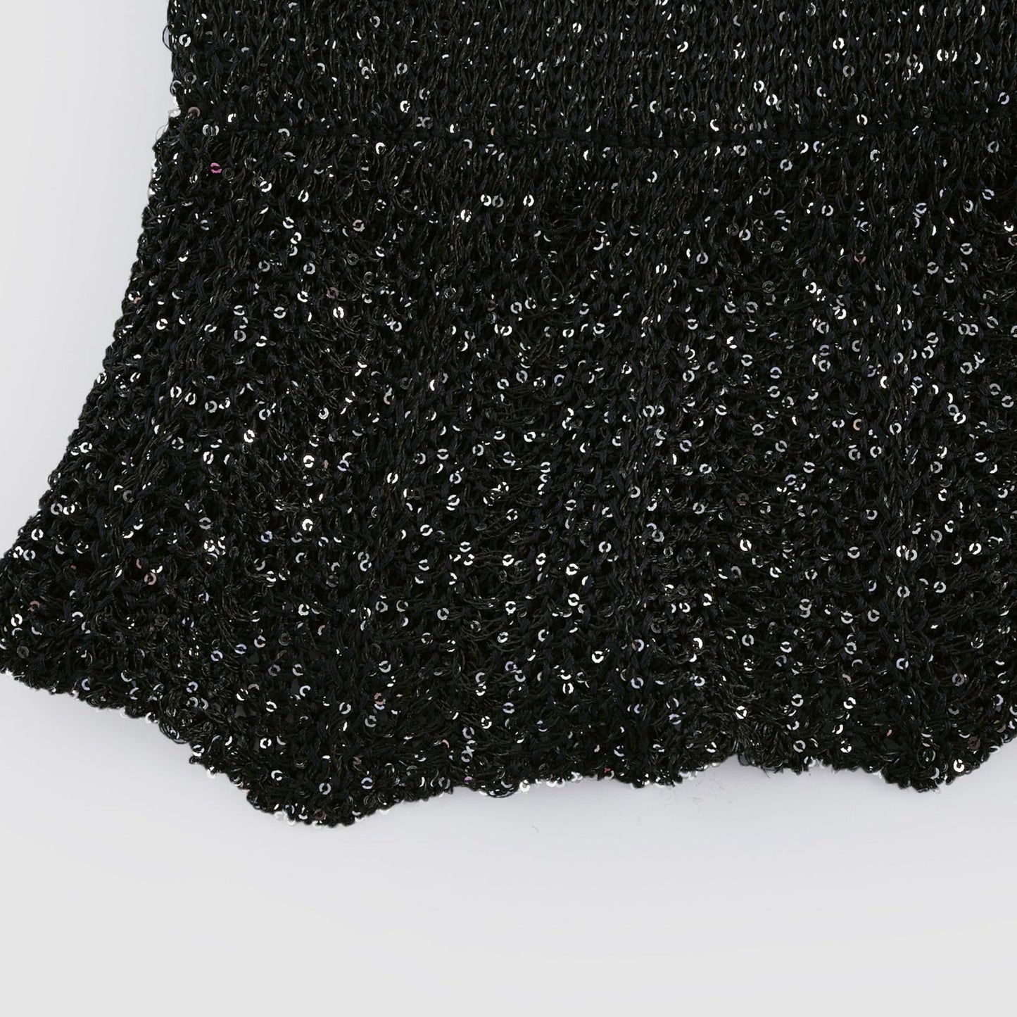 Tiered black sleeveless dress with sequin details throughout featuring a round neck and knitted design in mini length