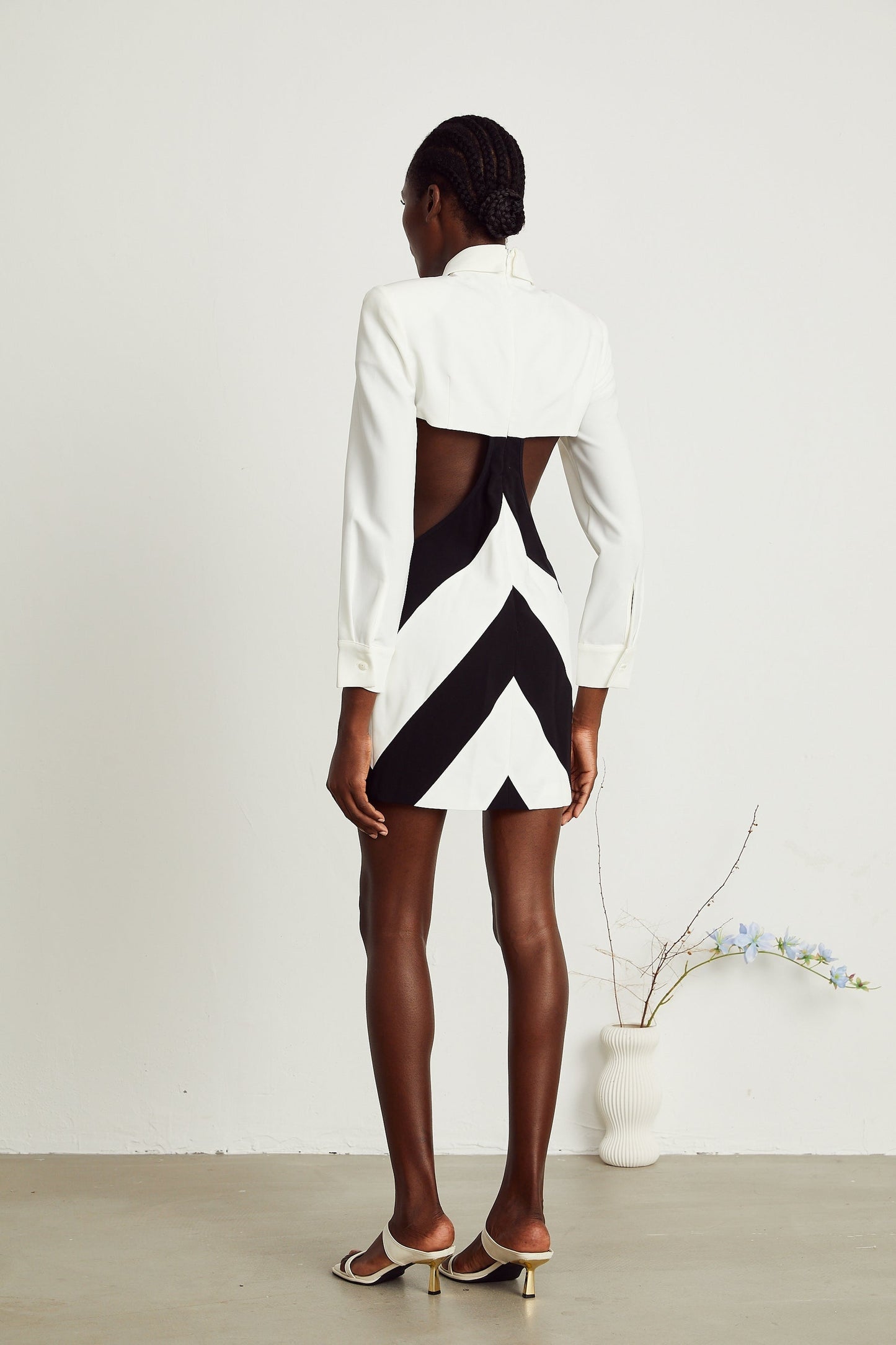 A short sleeveless mini dress with a neck tie and cut out detail in the bodice area