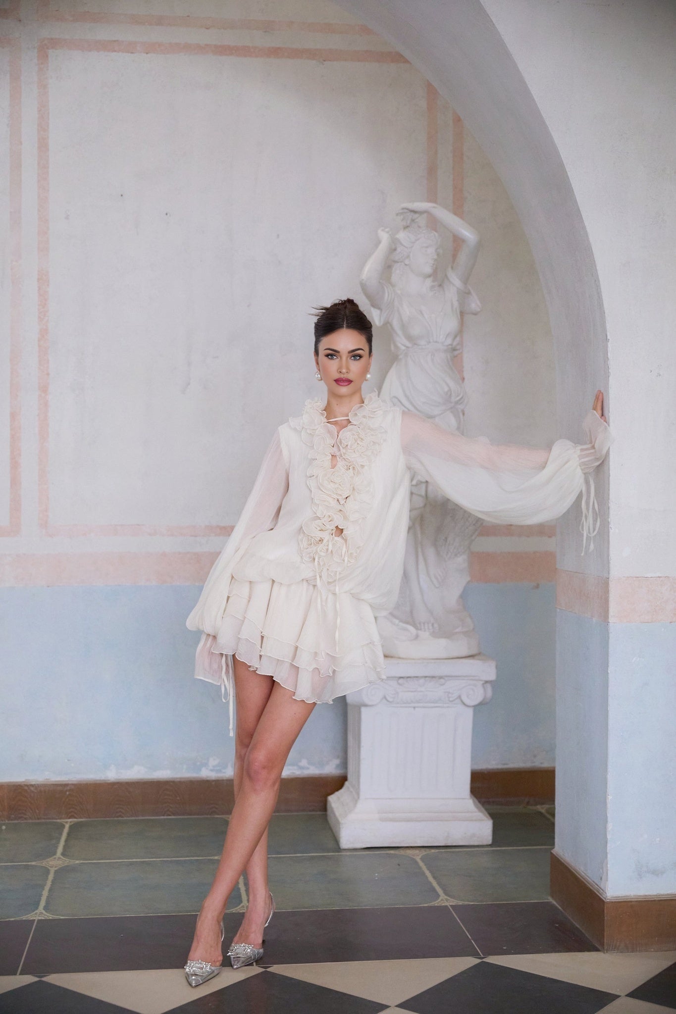 A short tiered mini dress in neutral tones featuring floral applique details and a delicate feminine design named Zephyrine