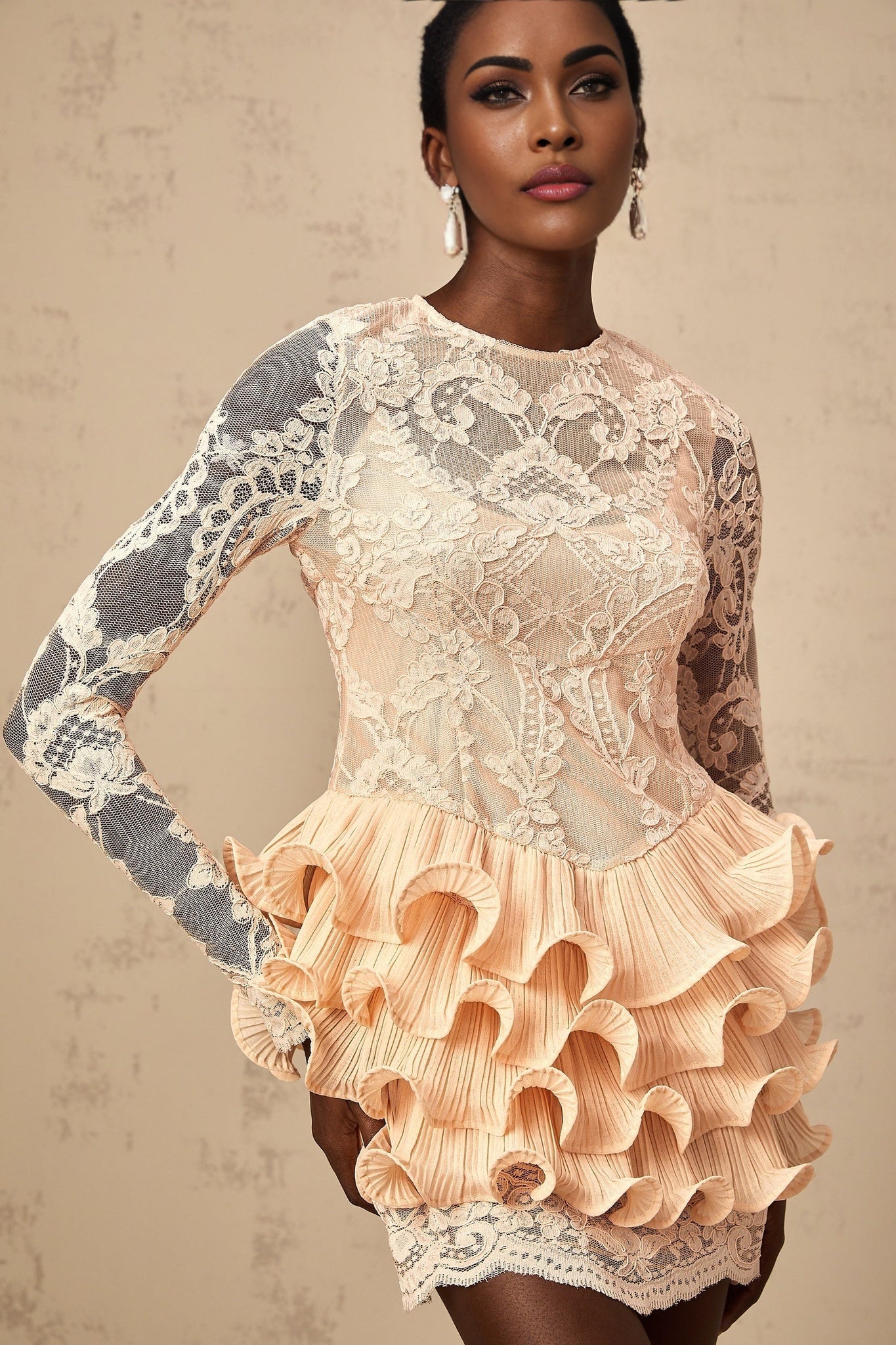 A short tiered mini dress with floral lace panels and a feminine design named Irene
