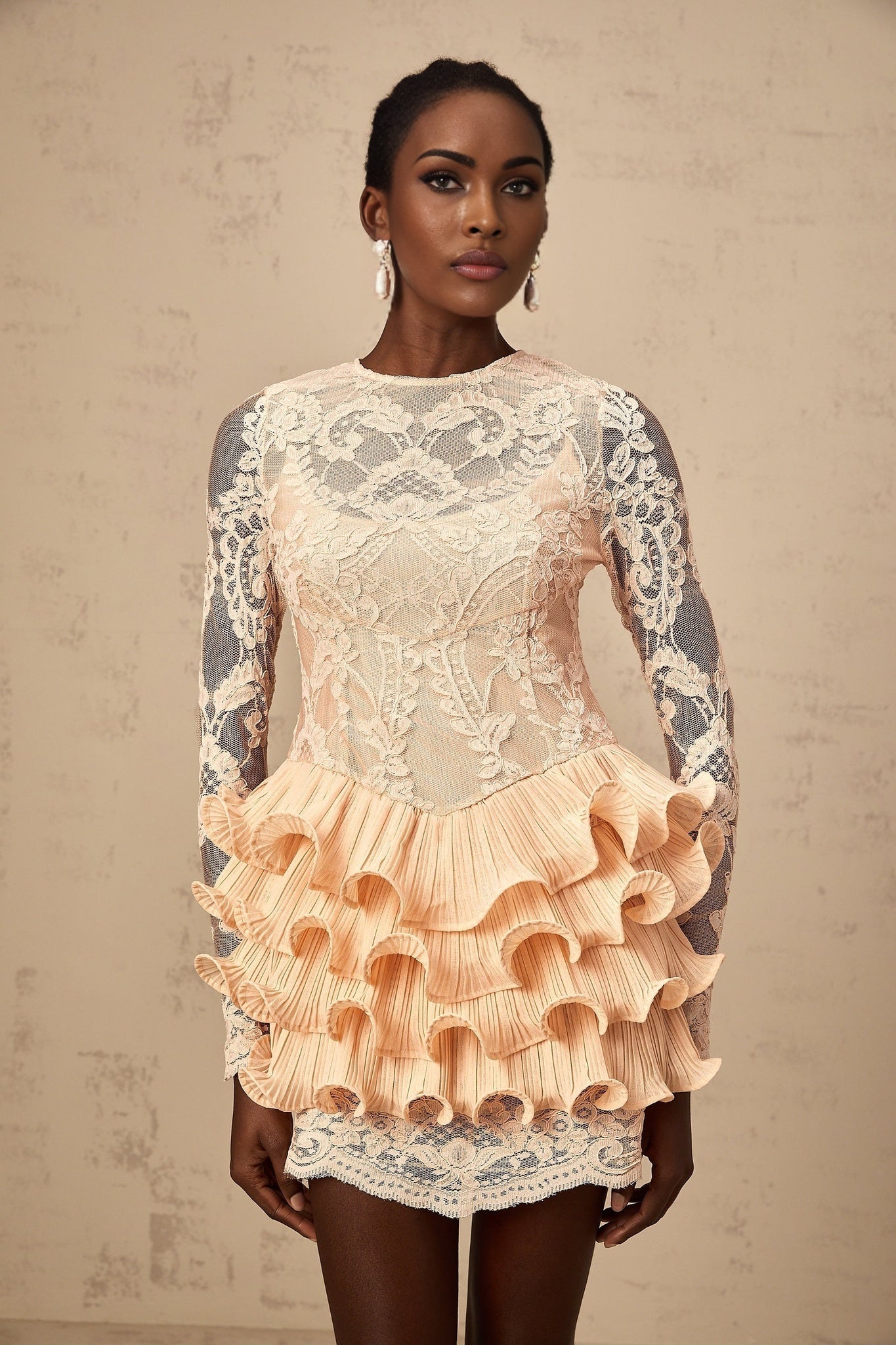 A short tiered mini dress with floral lace panels and a feminine design named Irene