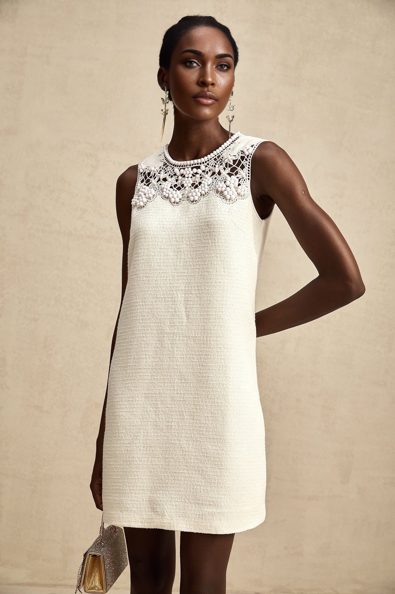 A short tweed mini dress with embroidery details and cut out sections