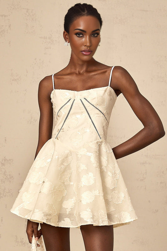 A short white dress with a floral jacquard pattern and mini length