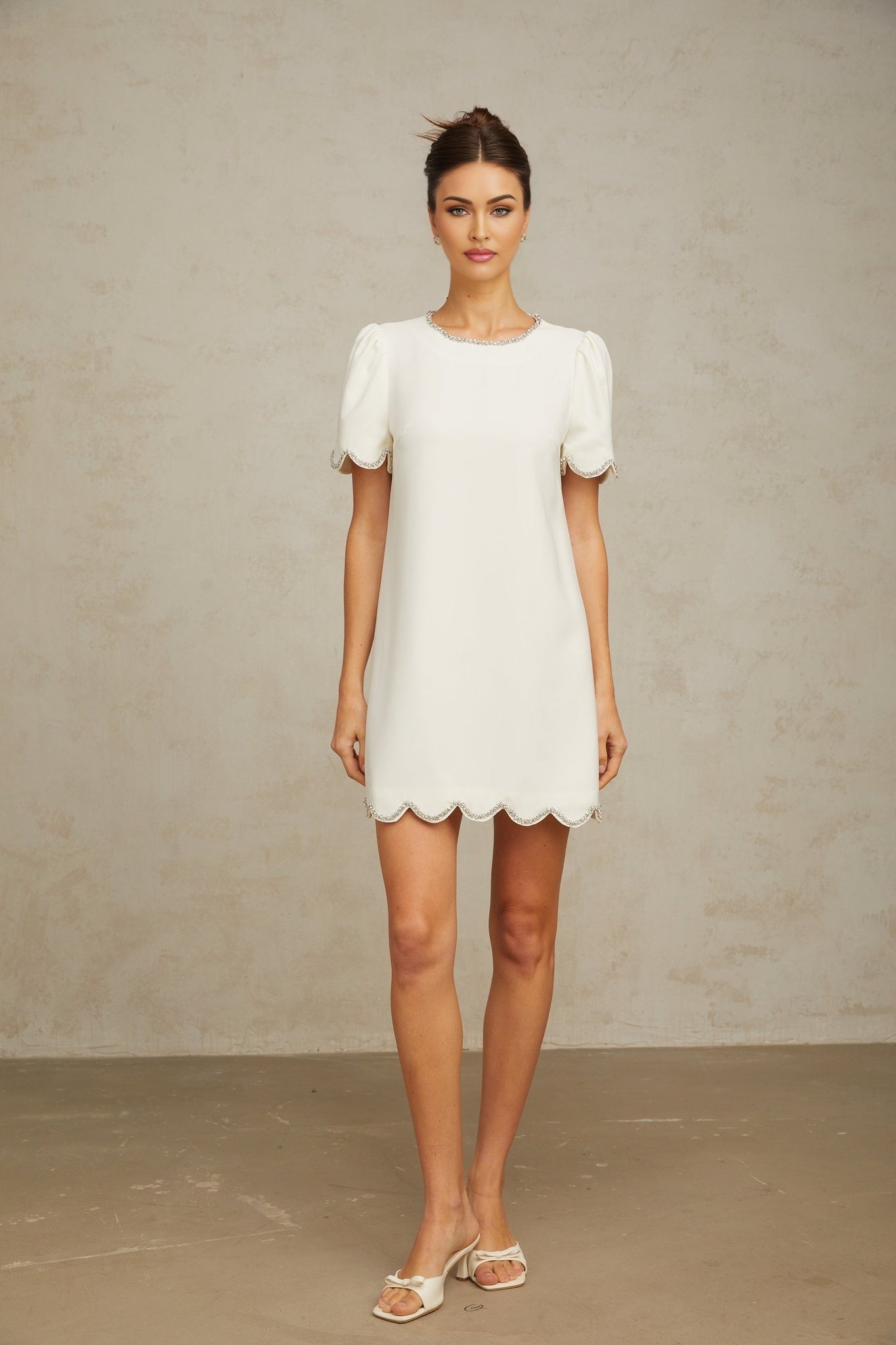 A short white mini dress adorned with crystal embellishments named Berenice