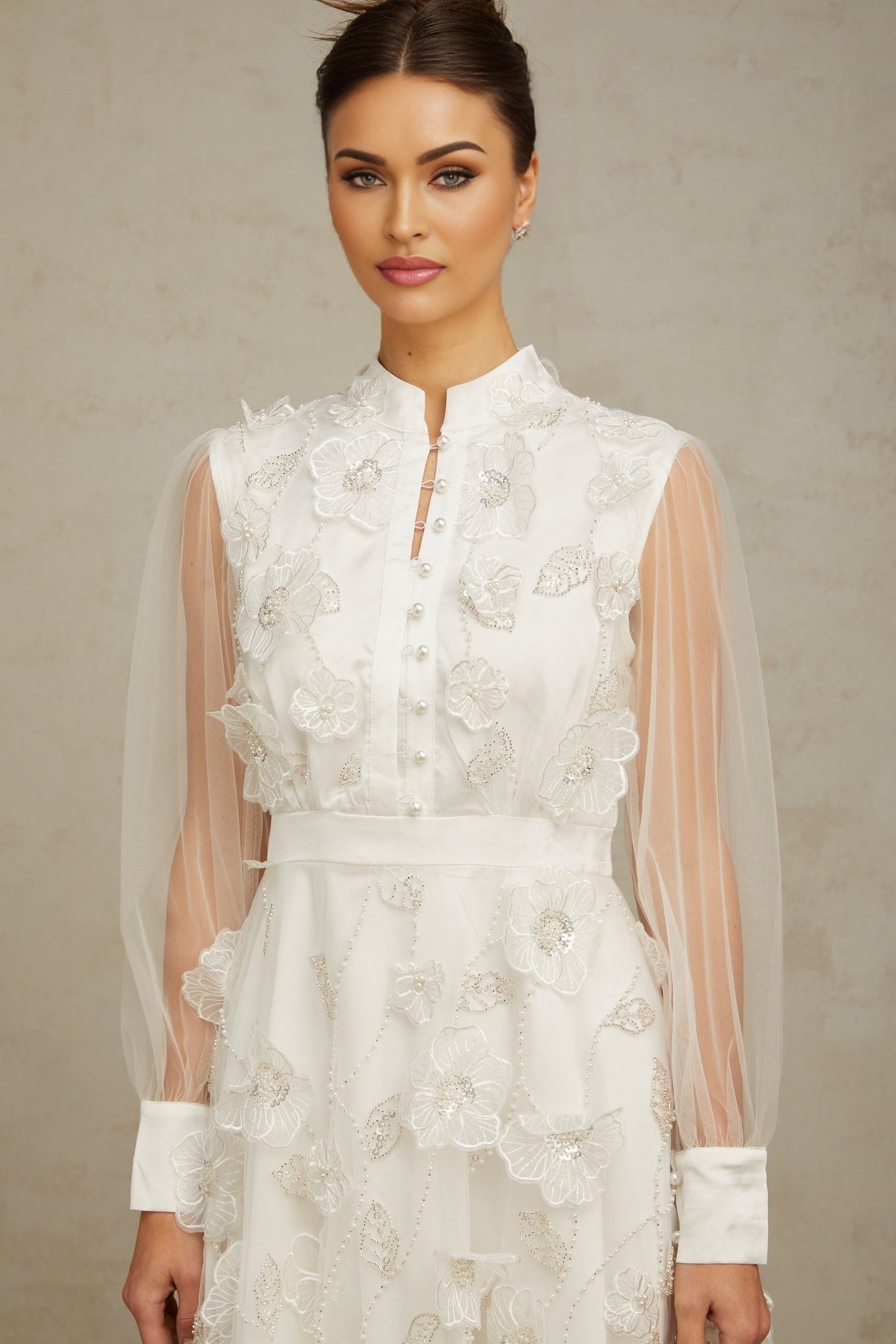 A short white mini dress with 3D floral petal details made of tulle fabric named Camille