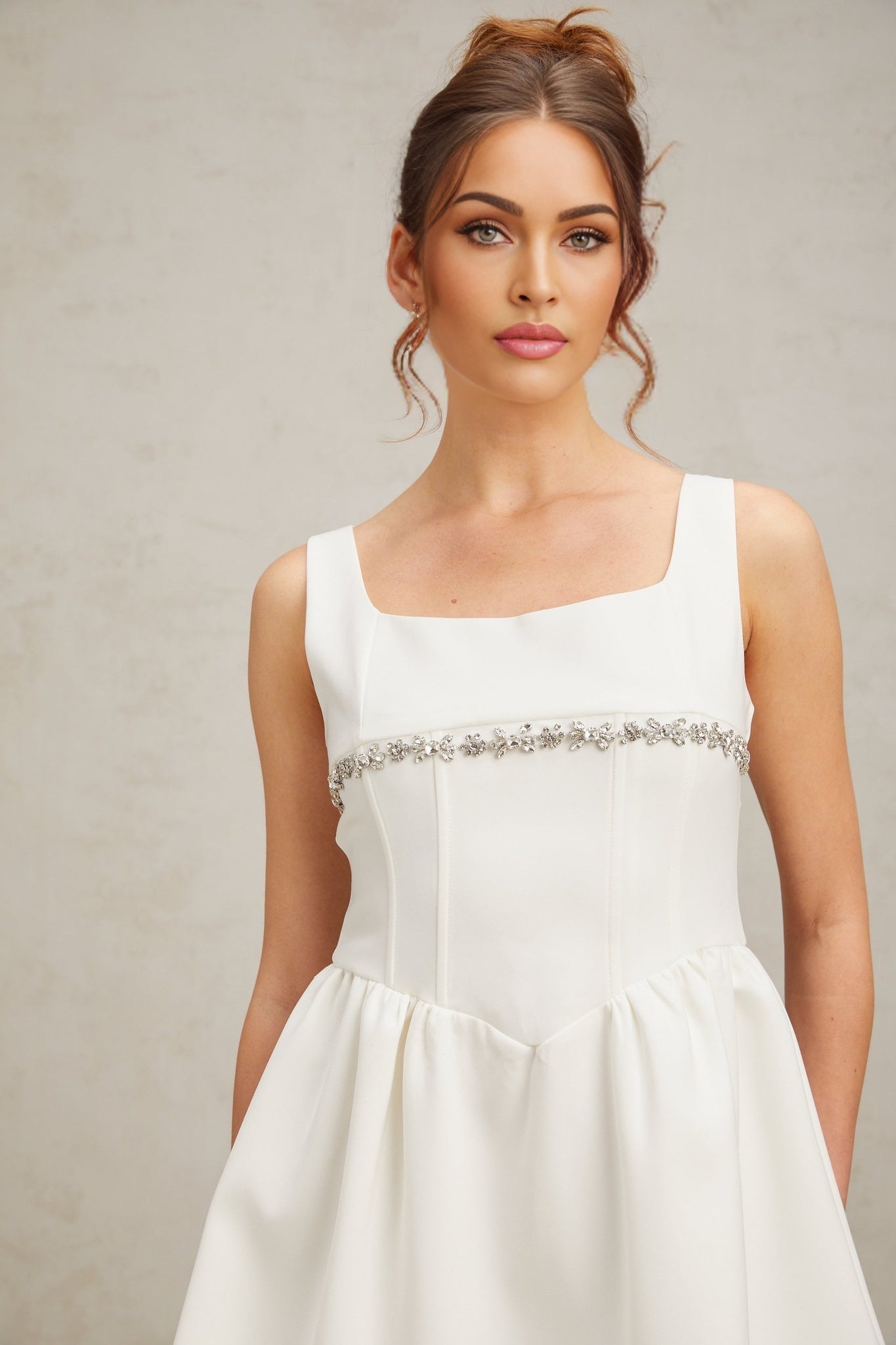 A short white mini dress with crystal embellishments named Flavia