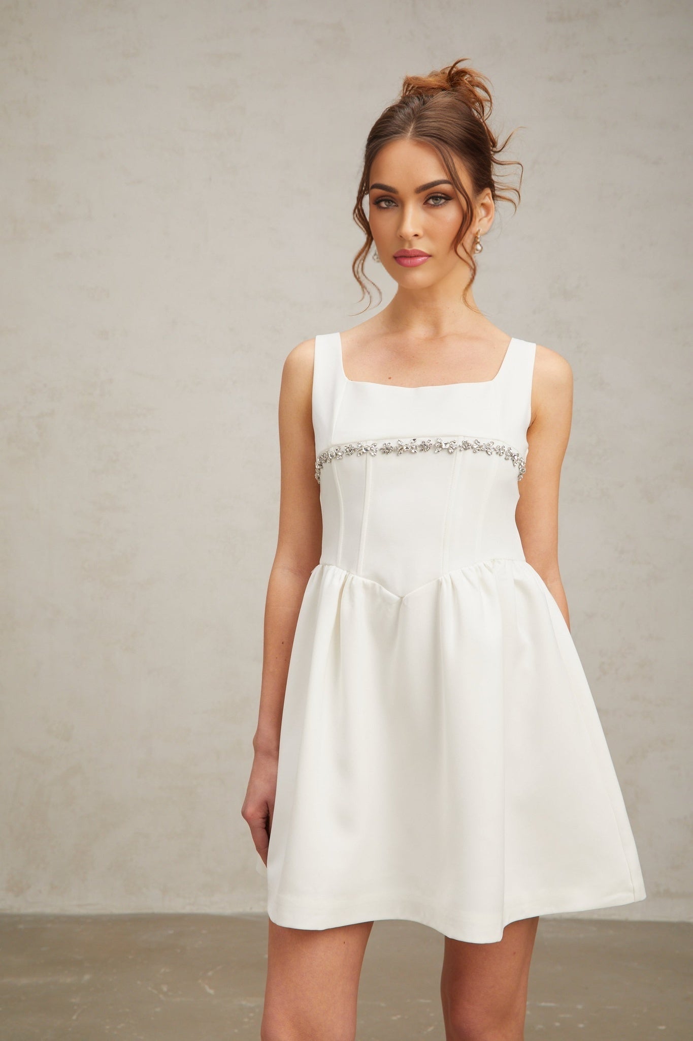A short white mini dress with crystal embellishments named Flavia