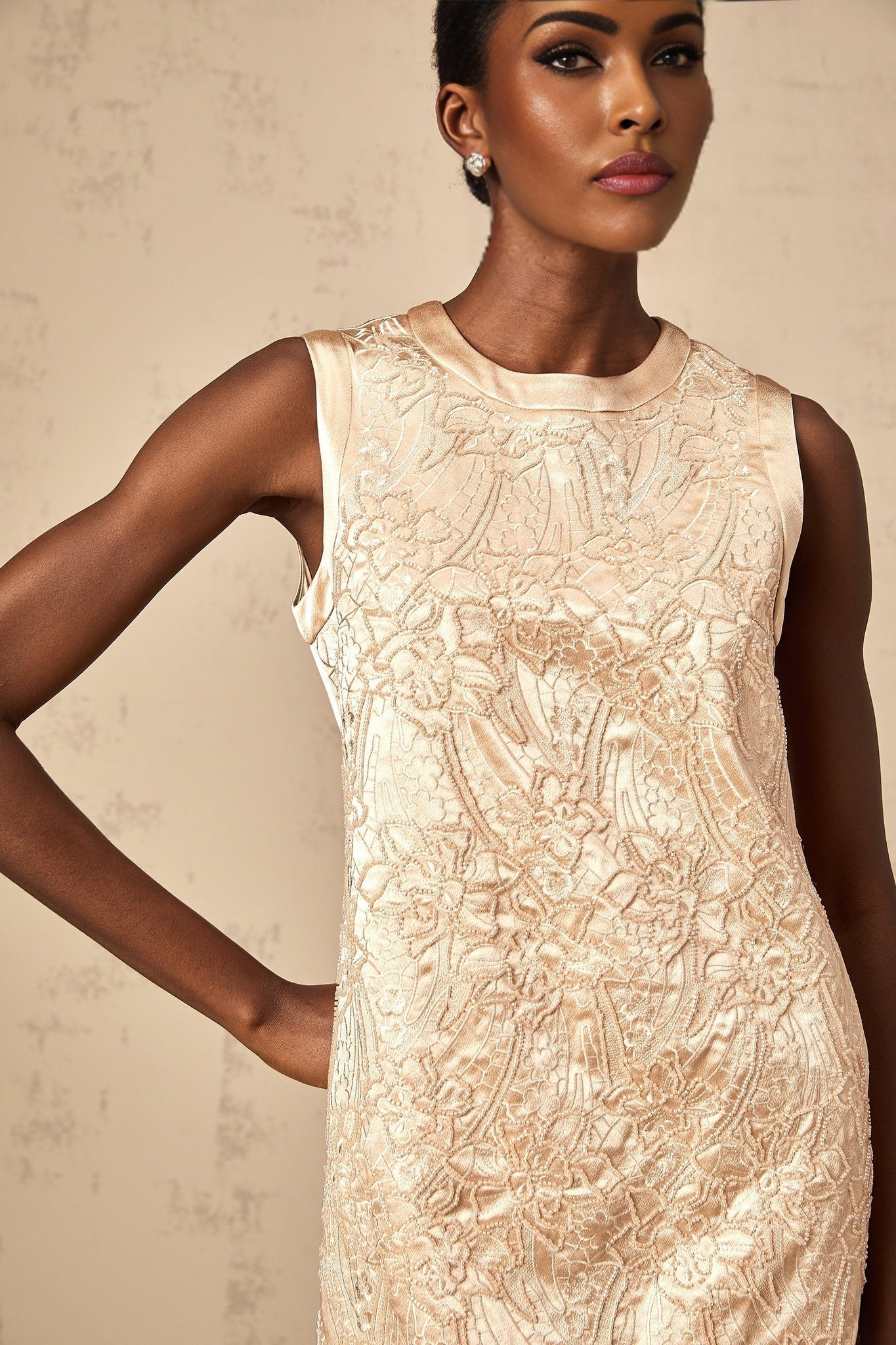 A short white mini dress with delicate embroidery and bead embellishments featuring a fitted bodice and flared skirt