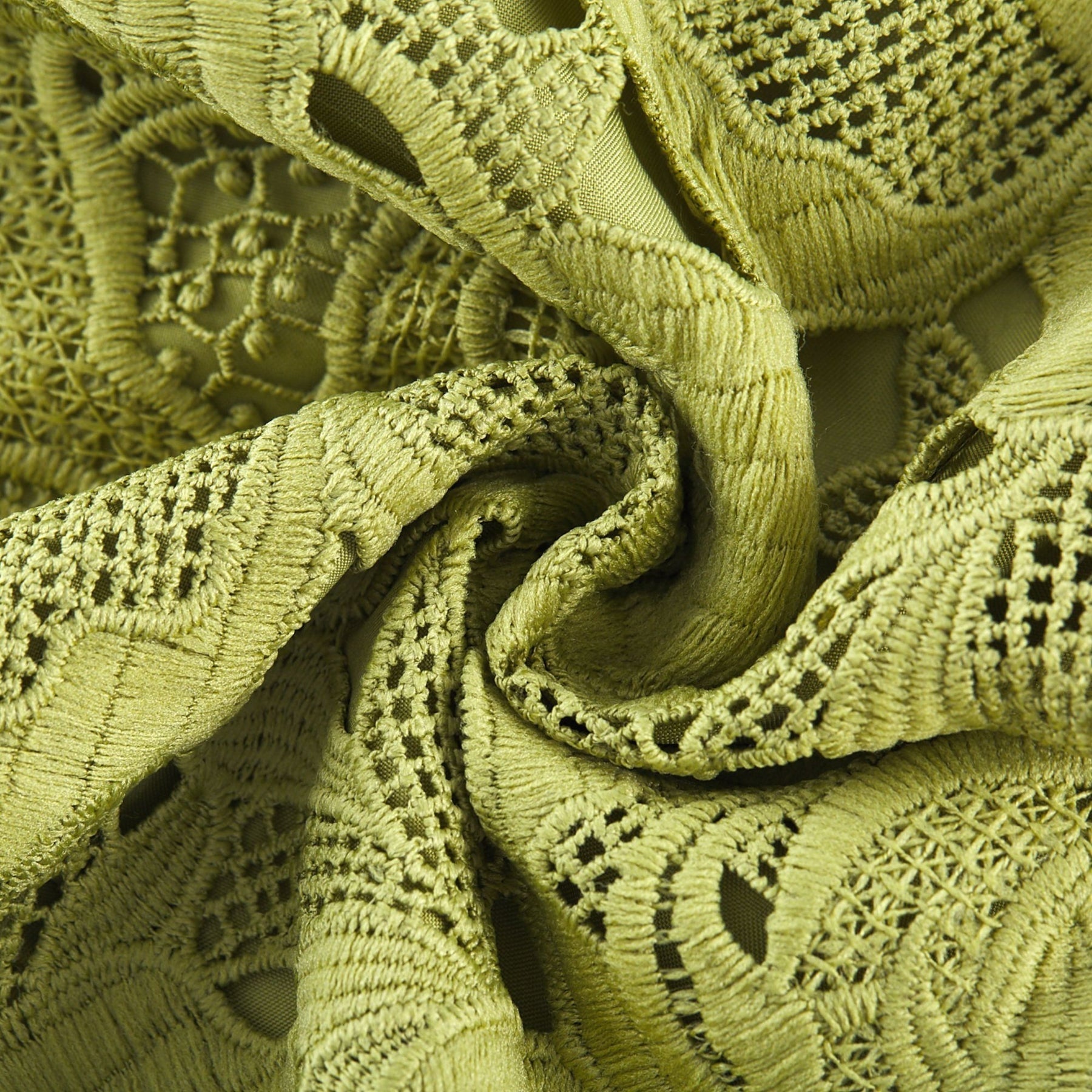 A short white minidress with embroidery details and cutout sections worn by a model against a plain background