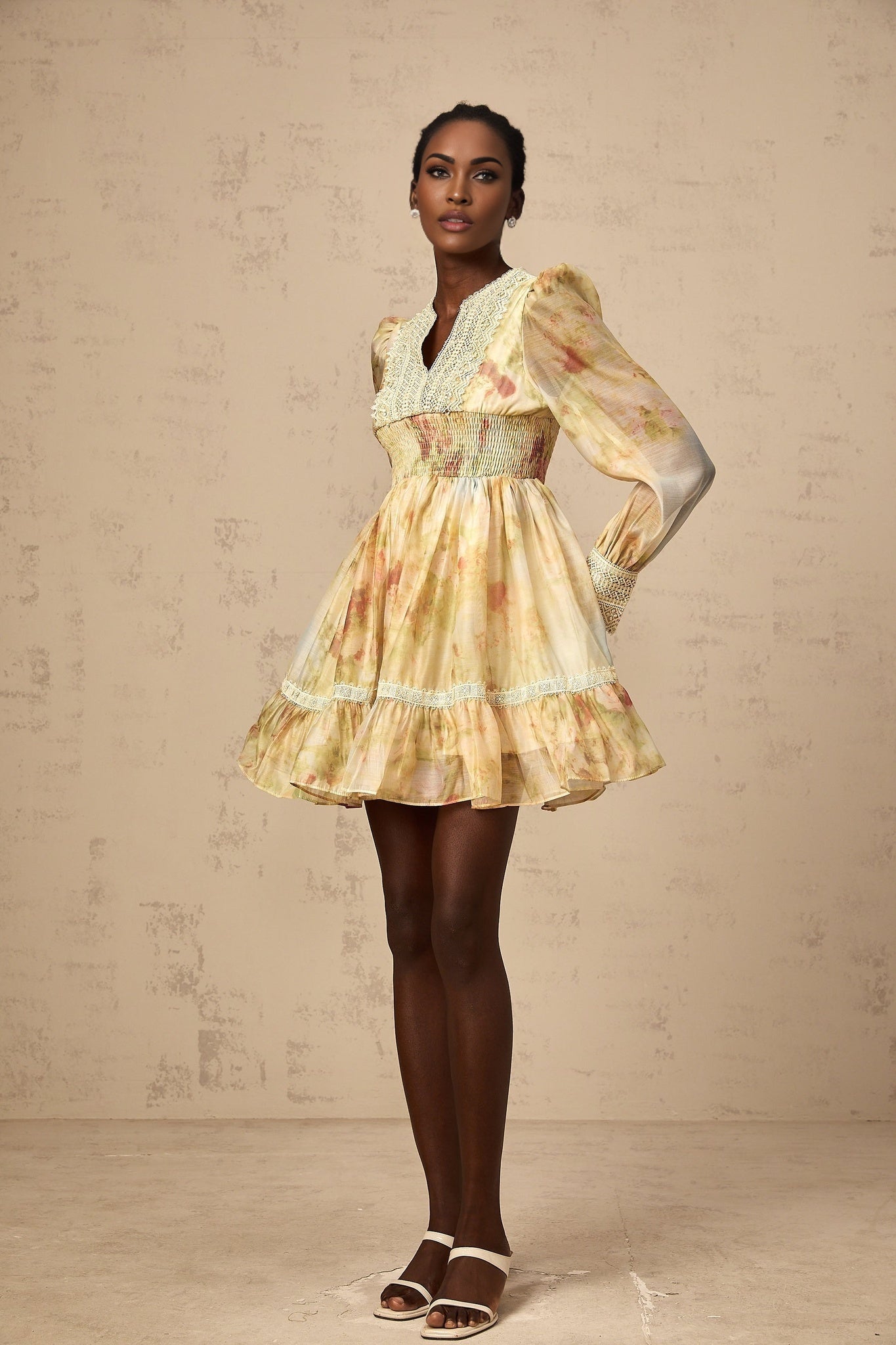 A short yellow dress with floral print and lace panels named Olivia featuring a mini length design