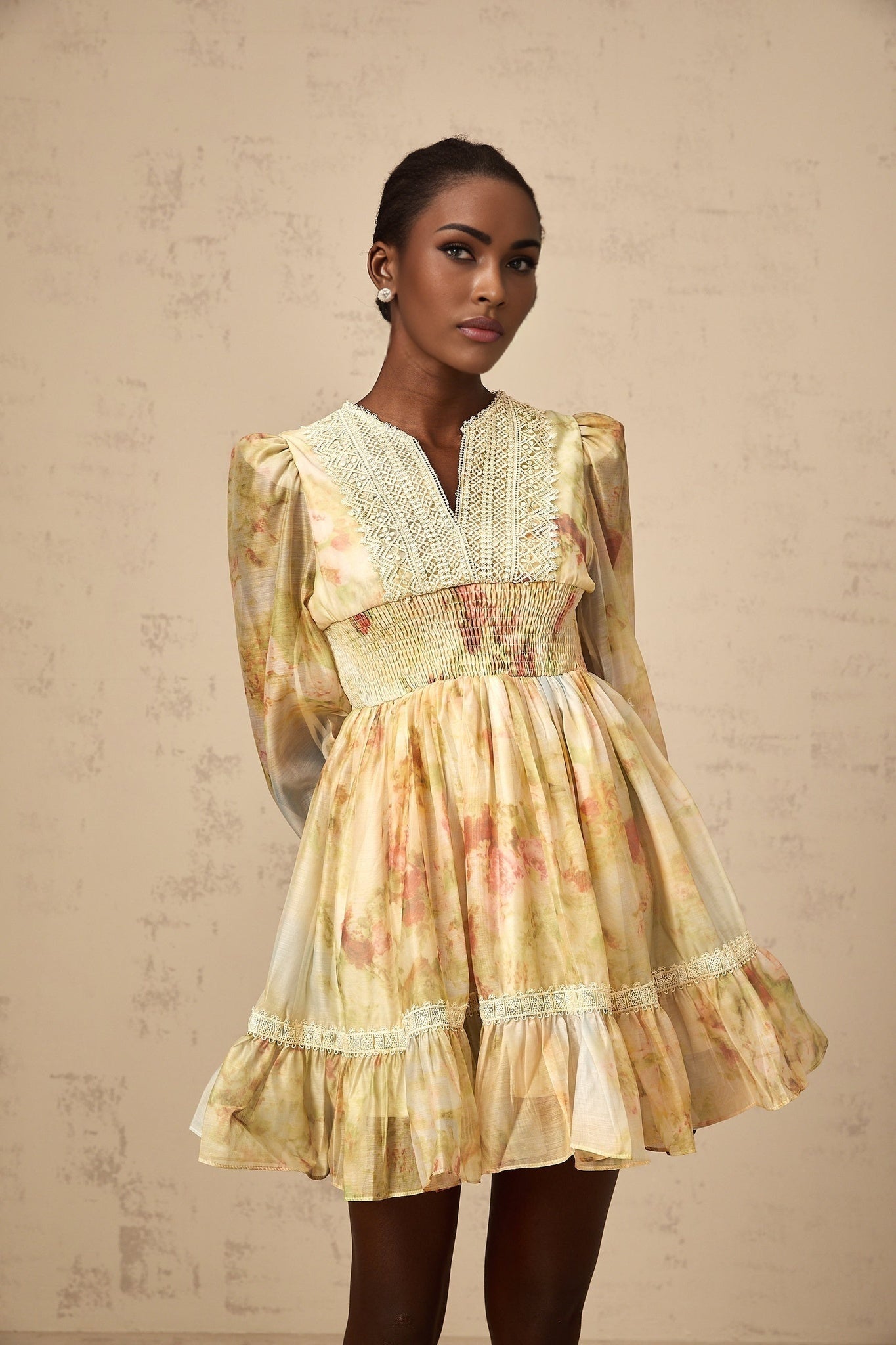 A short yellow dress with lace panels and a floral print pattern named Olivia