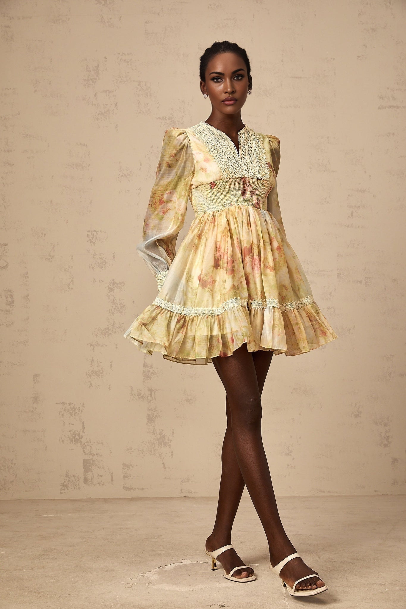 A short yellow dress with lace panels and a floral print pattern named Olivia