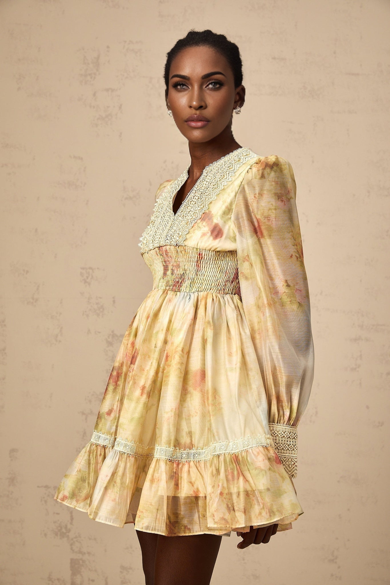 A short yellow mini dress with lace panels and a floral print pattern named Olivia