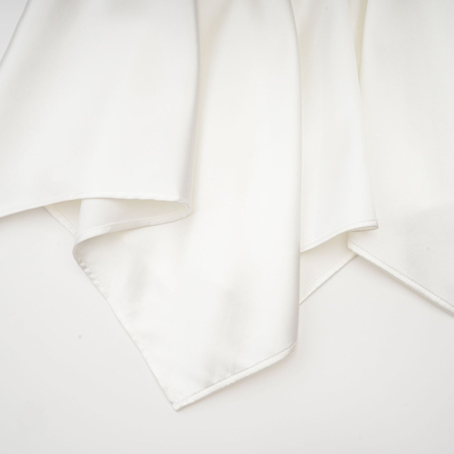 Sleeveless white satin dress with square neck spaghetti straps and asymmetric hem reaching thigh length Rear zip fastening Made of 56% Polyester 44% Acetate