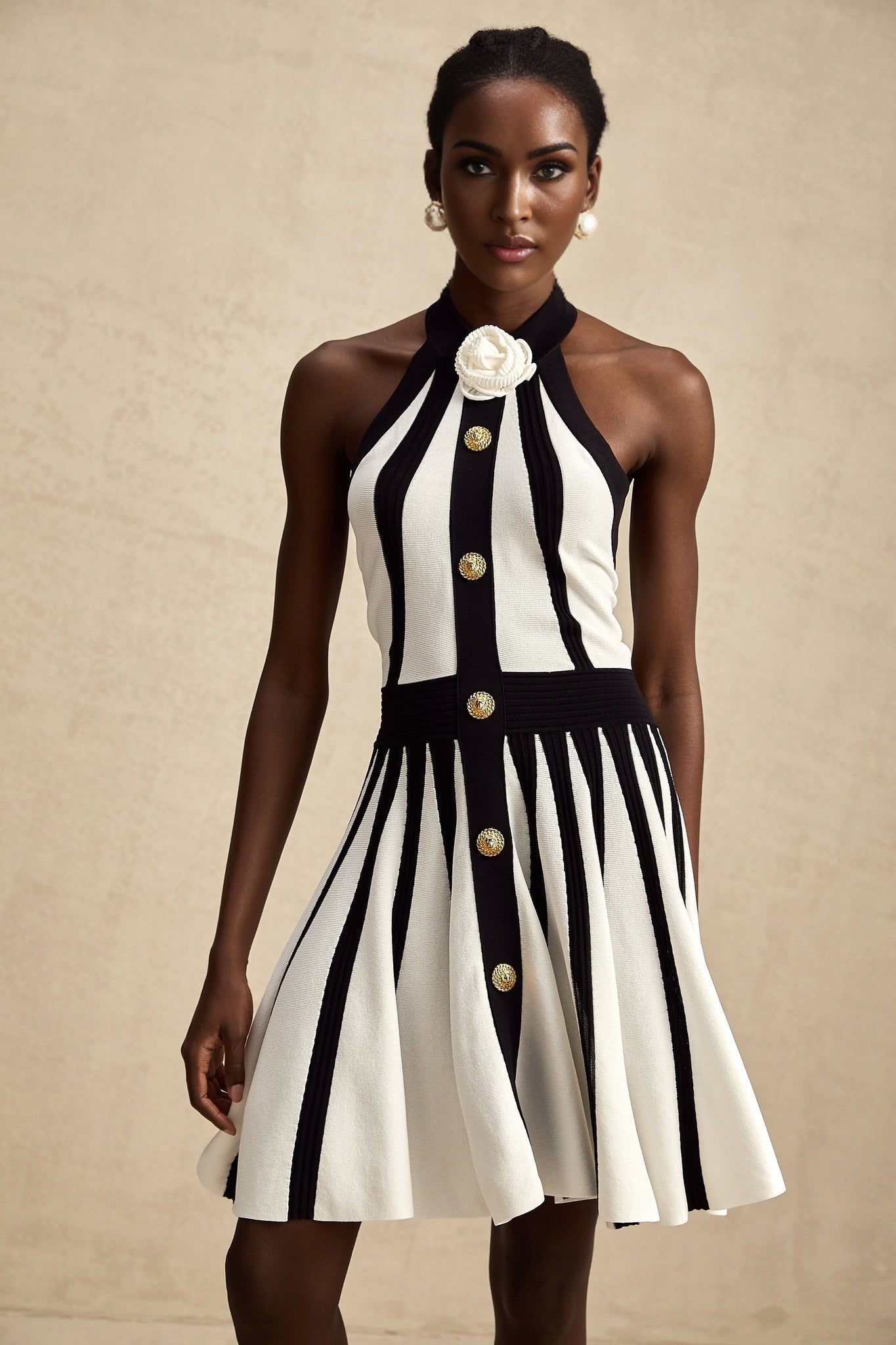 A sleeveless knitted mini dress in contrasting colors named Celeste