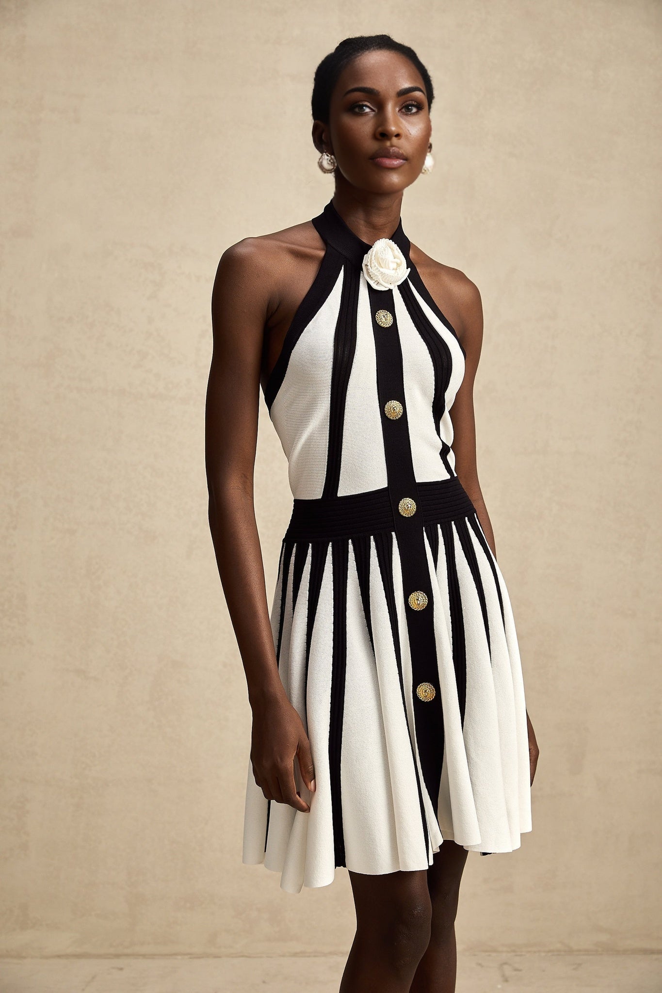 A sleeveless knitted mini dress with contrasting colors named Celeste