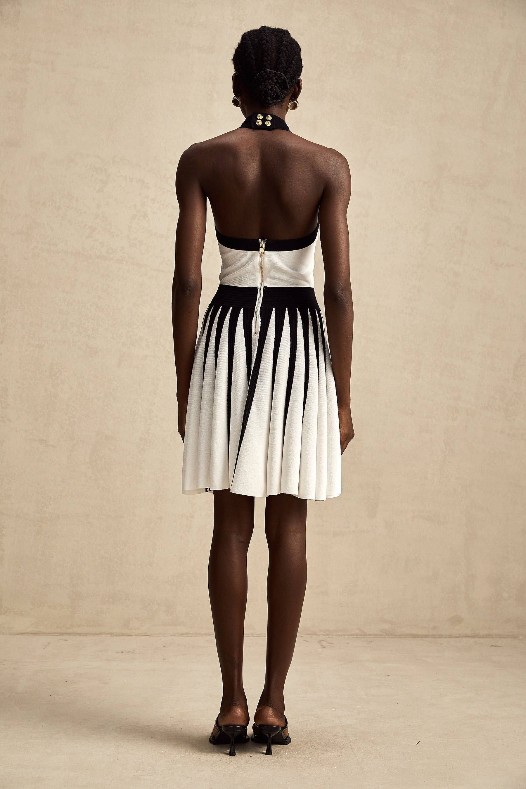 A sleeveless knitted mini dress with contrasting colors named Celeste