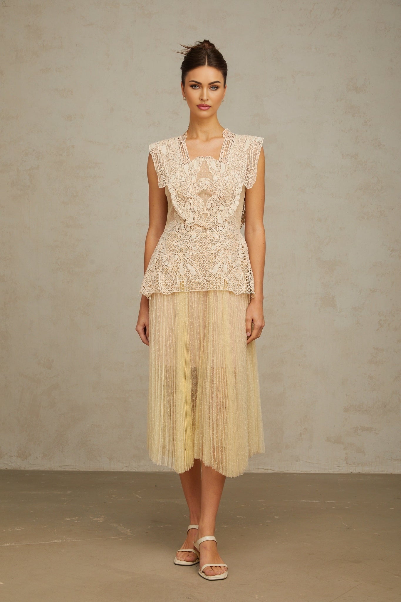 A sleeveless midi dress with floral lace panels and tulle fabric in neutral tones featuring a fitted bodice and flowy skirt