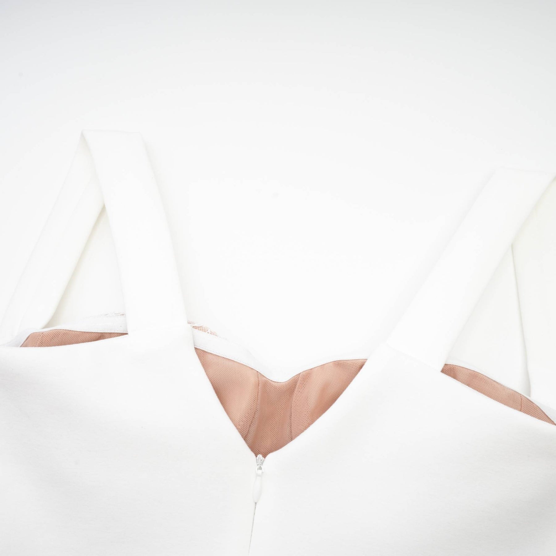 A sleeveless midi length dress in a bandage style with a bustier top featuring a fitted silhouette in a light metallic color