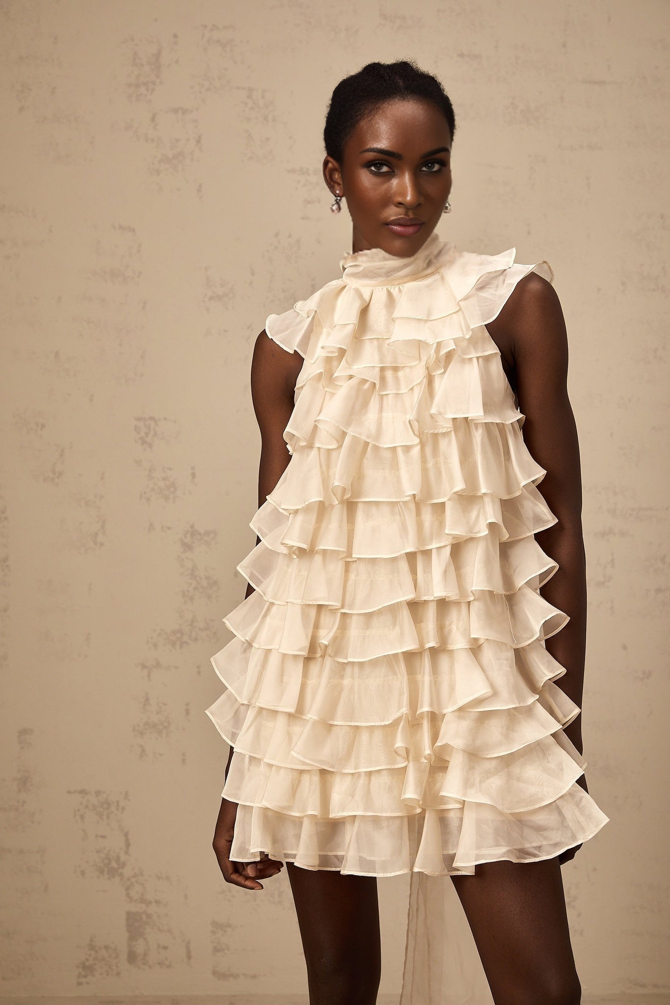 A sleeveless mini dress with a tiered flounce design named Jessica